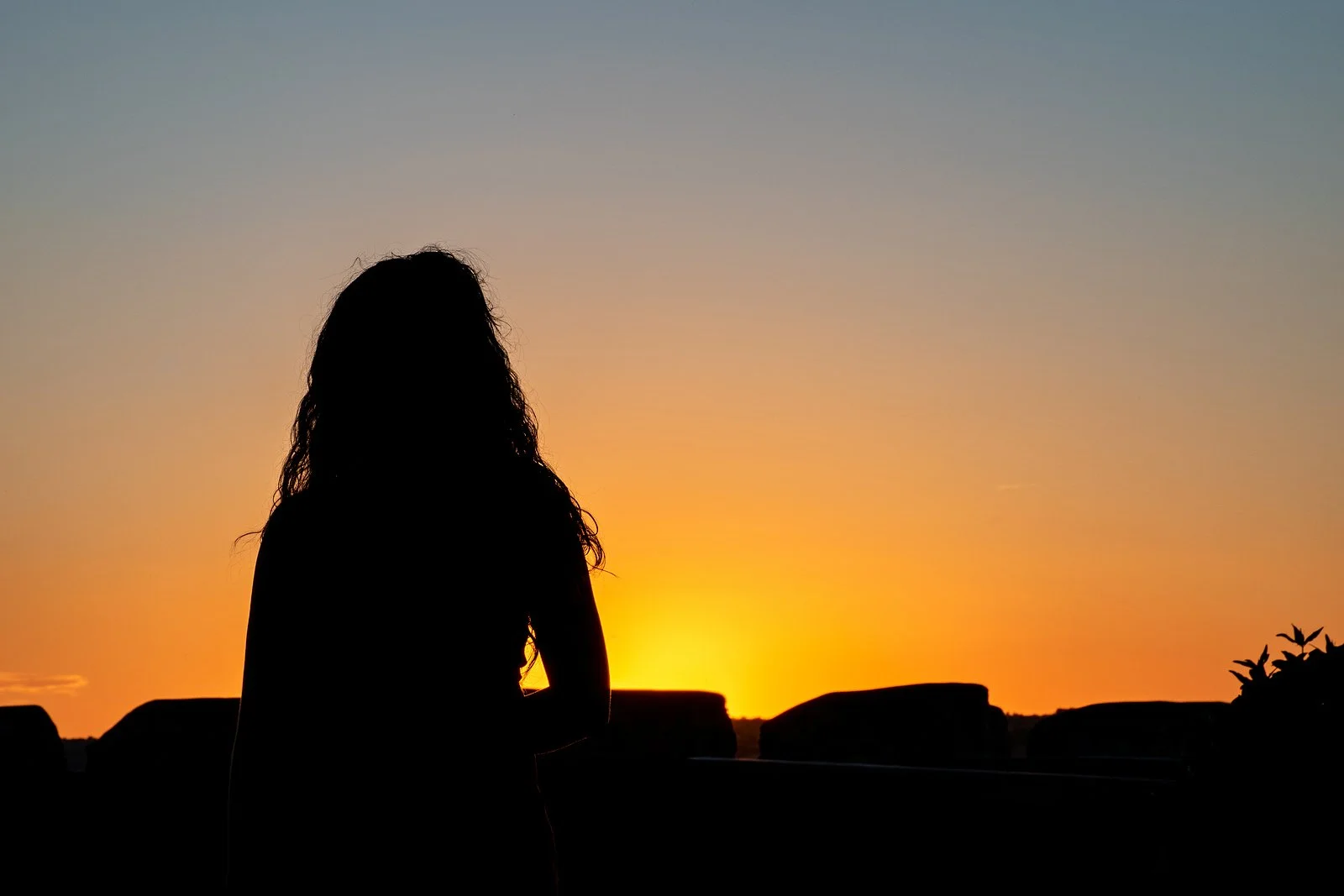 Image of a person's silhouette against a sunset