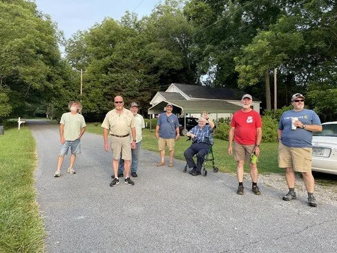 Many men that helped install the antenna pose for a picture.