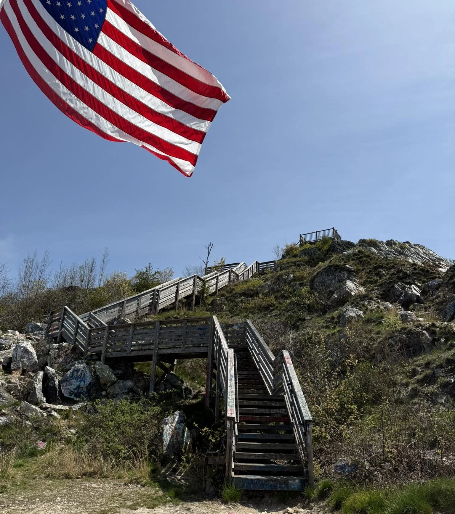 Stairs leading up to an observation platform on top of Rabun Bald in Rabun County GA. The American Flag stands in the foreground.