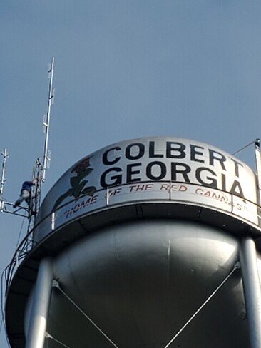 A picture from the ground looking up at George, KZ4GRK, installing one of the antennas at the top of the tower.