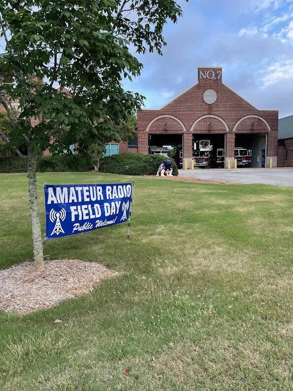 Banner set up in front of Athens-Clarke County Fire Station  Number 7 for Field Day 2022. The banner reades "Amateur Radio Field Day Public Welcome".