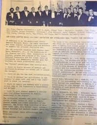 A newspaper article with a black and white photograph of a group of men in suits at the top.