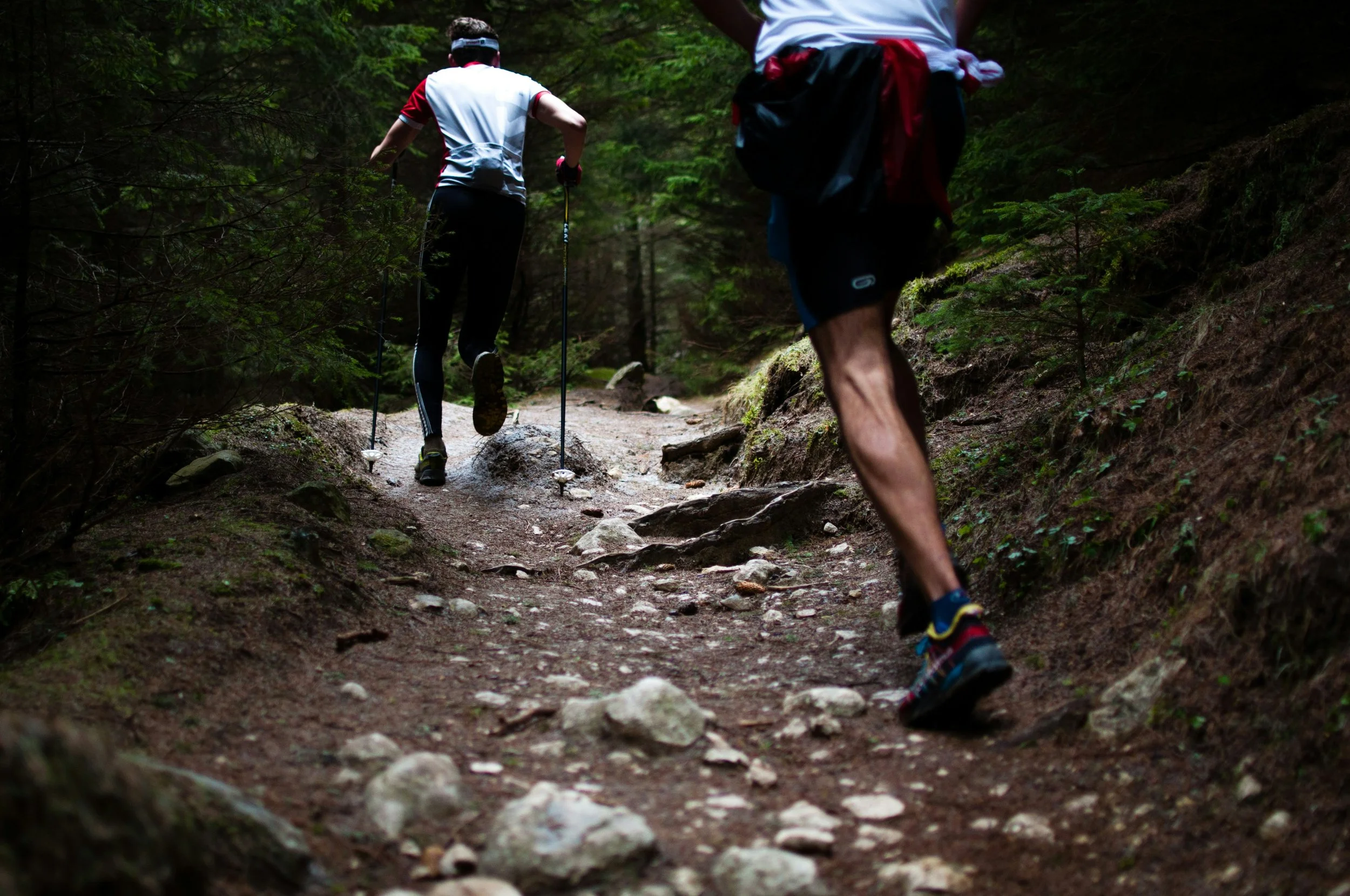 Two trail runners running uphill