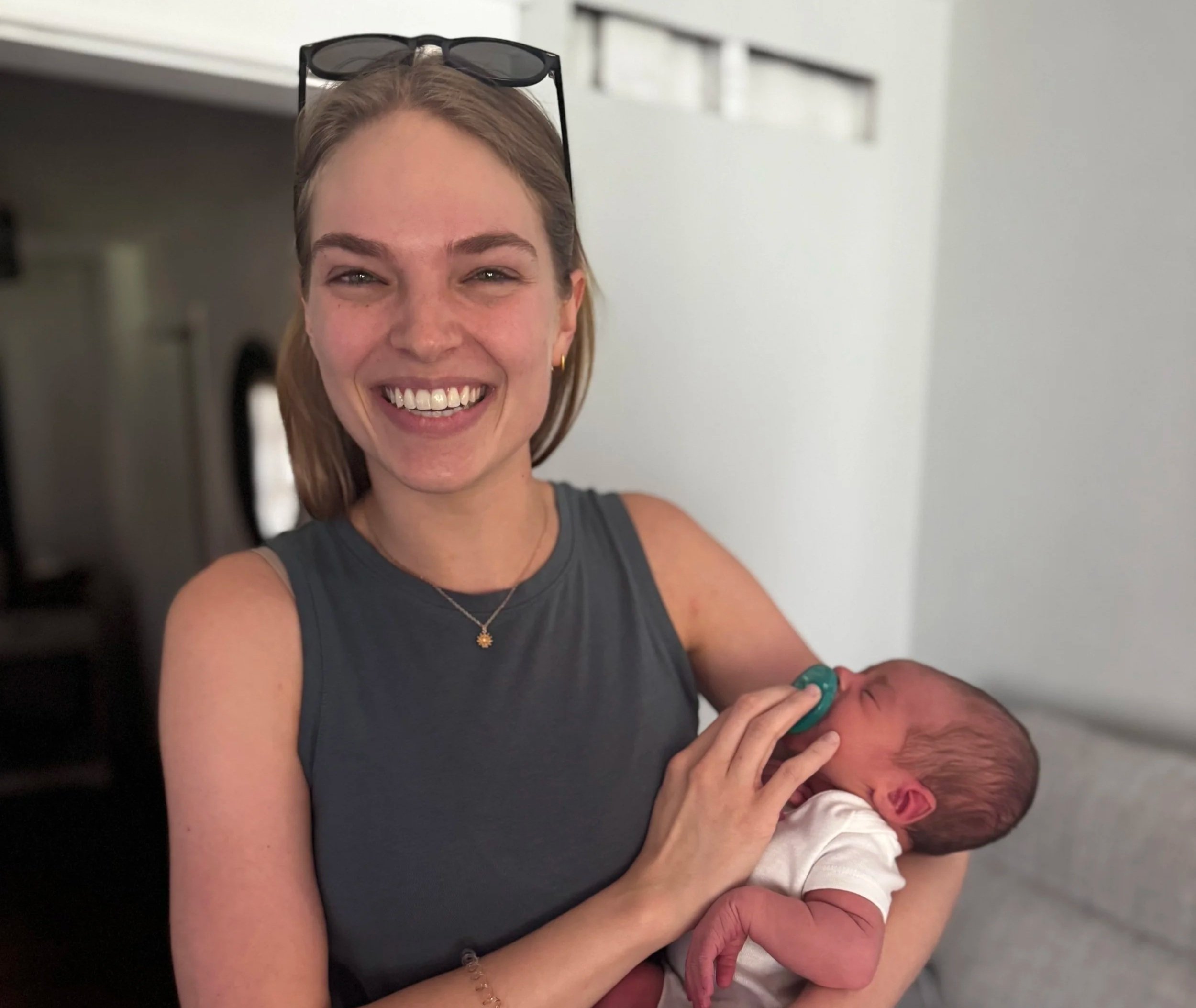 Birth Doula Smiling Holding Baby at Postpartum Lactation Visit 