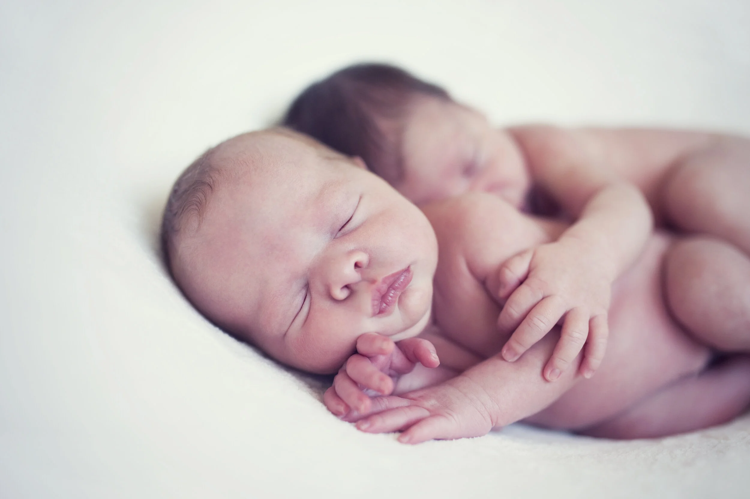 naked newborns hug.jpeg