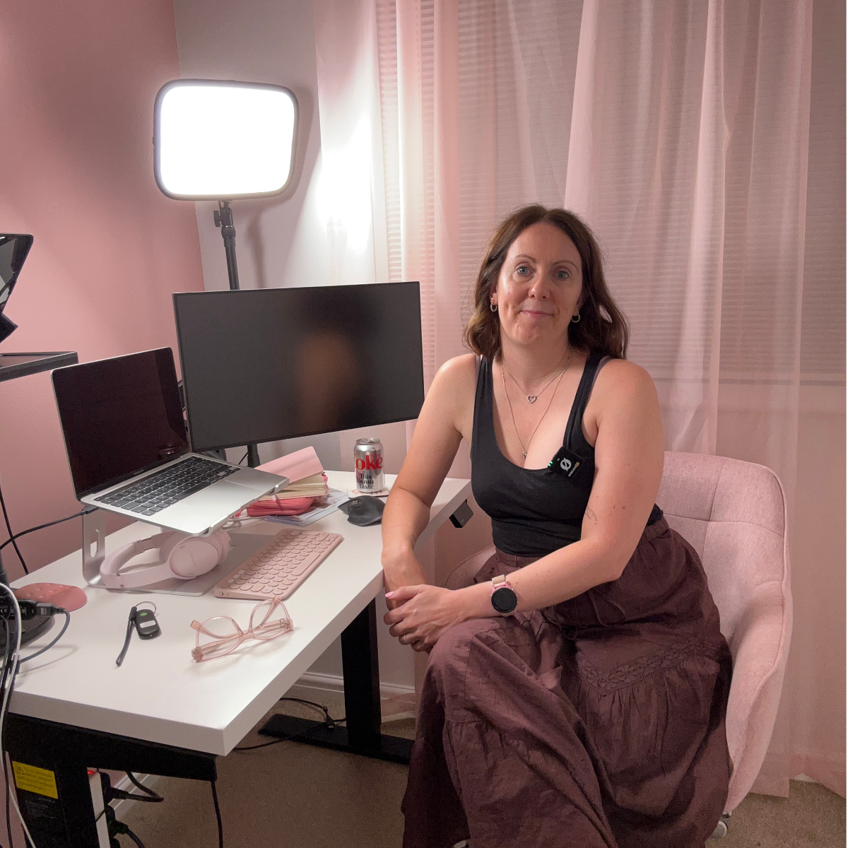 Louise Laurie sitting at her home office desk with a laptop and monitor, beside the ChatGPT Work Mode course content.