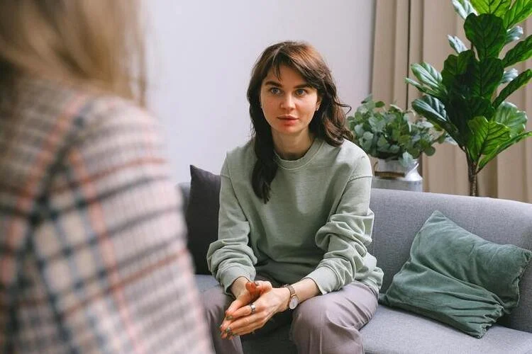 Woman attending a weekly psychology therapy session in a calm setting