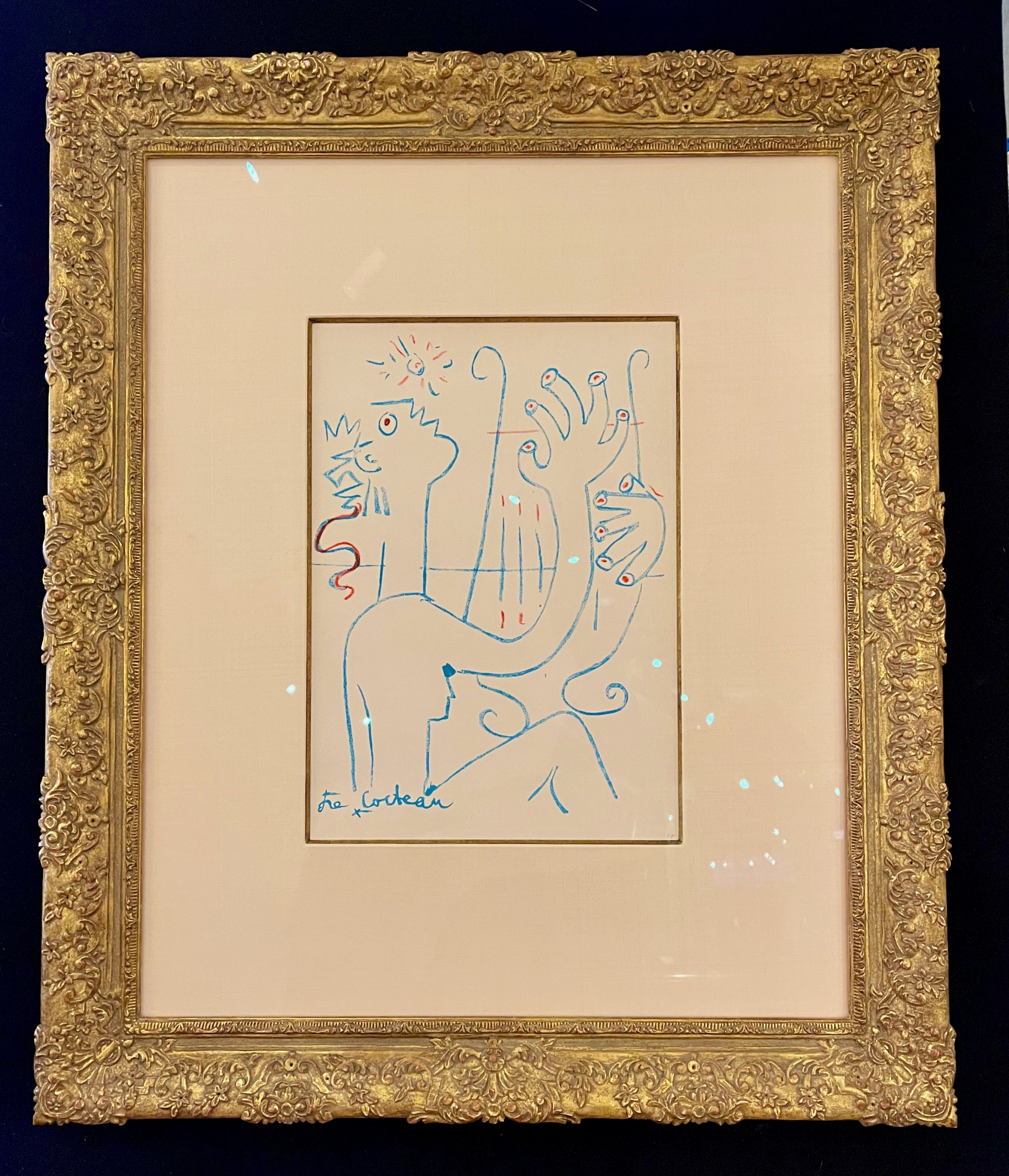 Picaso line drawing in a hand carved gold frame with silk and gold filet mat