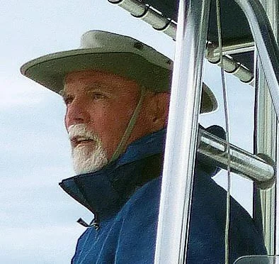 a headshot of a man with a gray beard