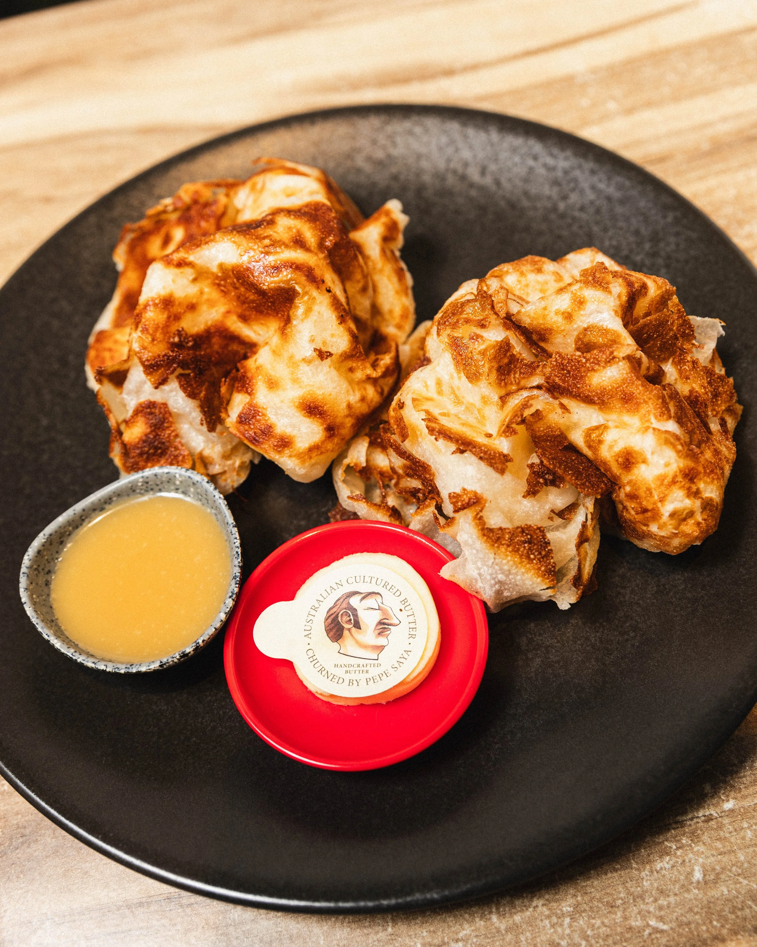 Served with Pepe Saya butter and your choice of condiments. This one is served with our house-made coconut jam