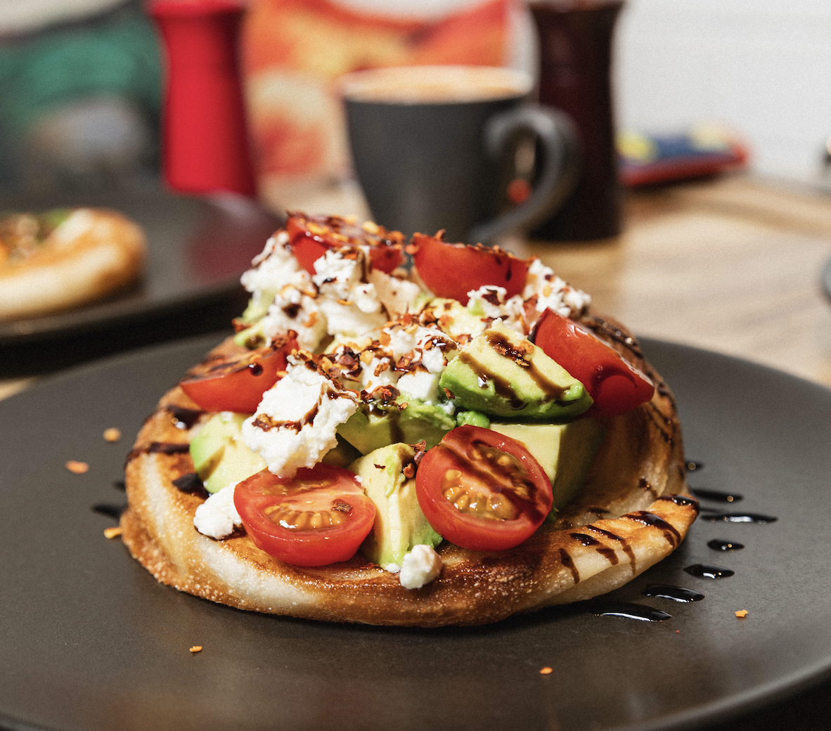 Avocado roti coin with Persian feta, cherry tomatoes, balsamic and dried chilli at Kafe Kooks, Ultimo