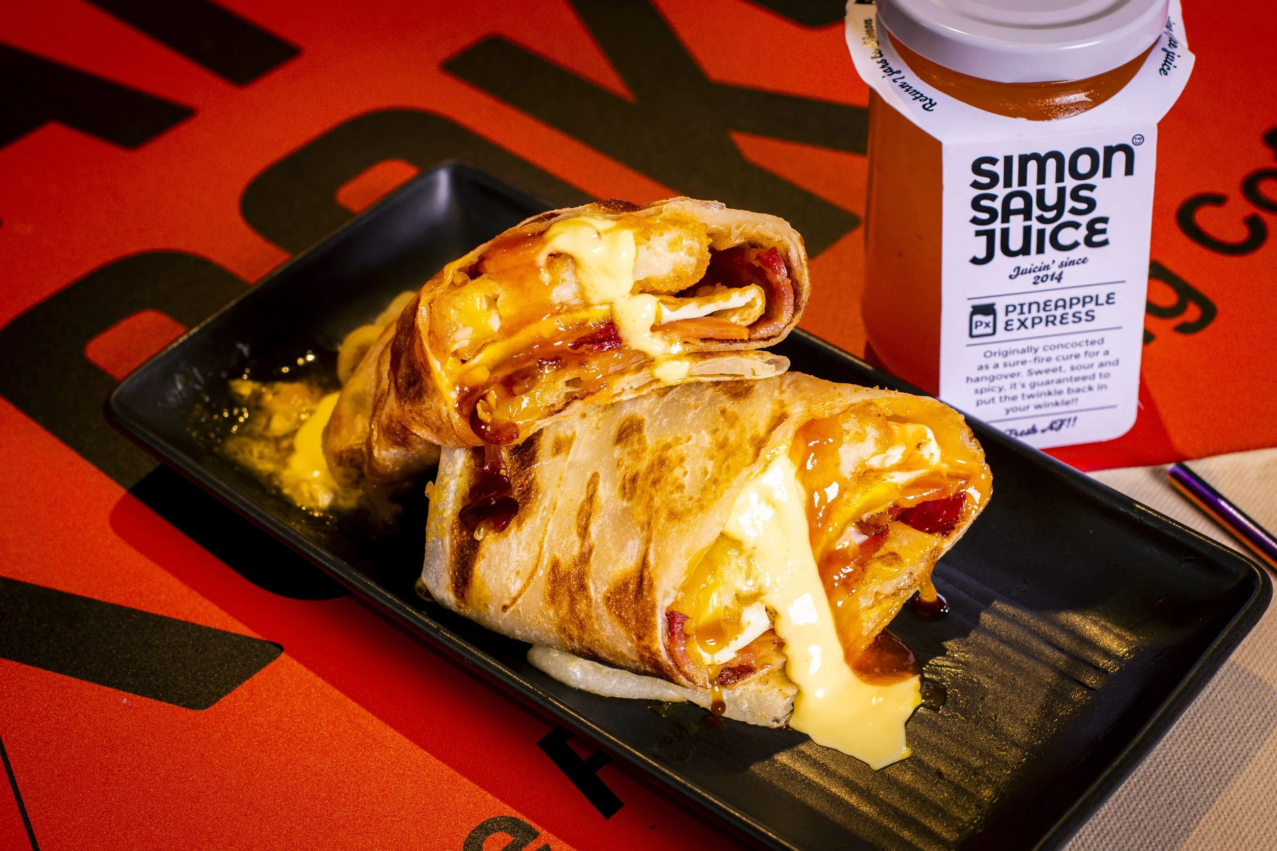 Recovery breakfast roti wrap with egg, bacon and hash brown, and a Simon Says Pineapple Express juice, at Kafe Kooks, Ultimo
