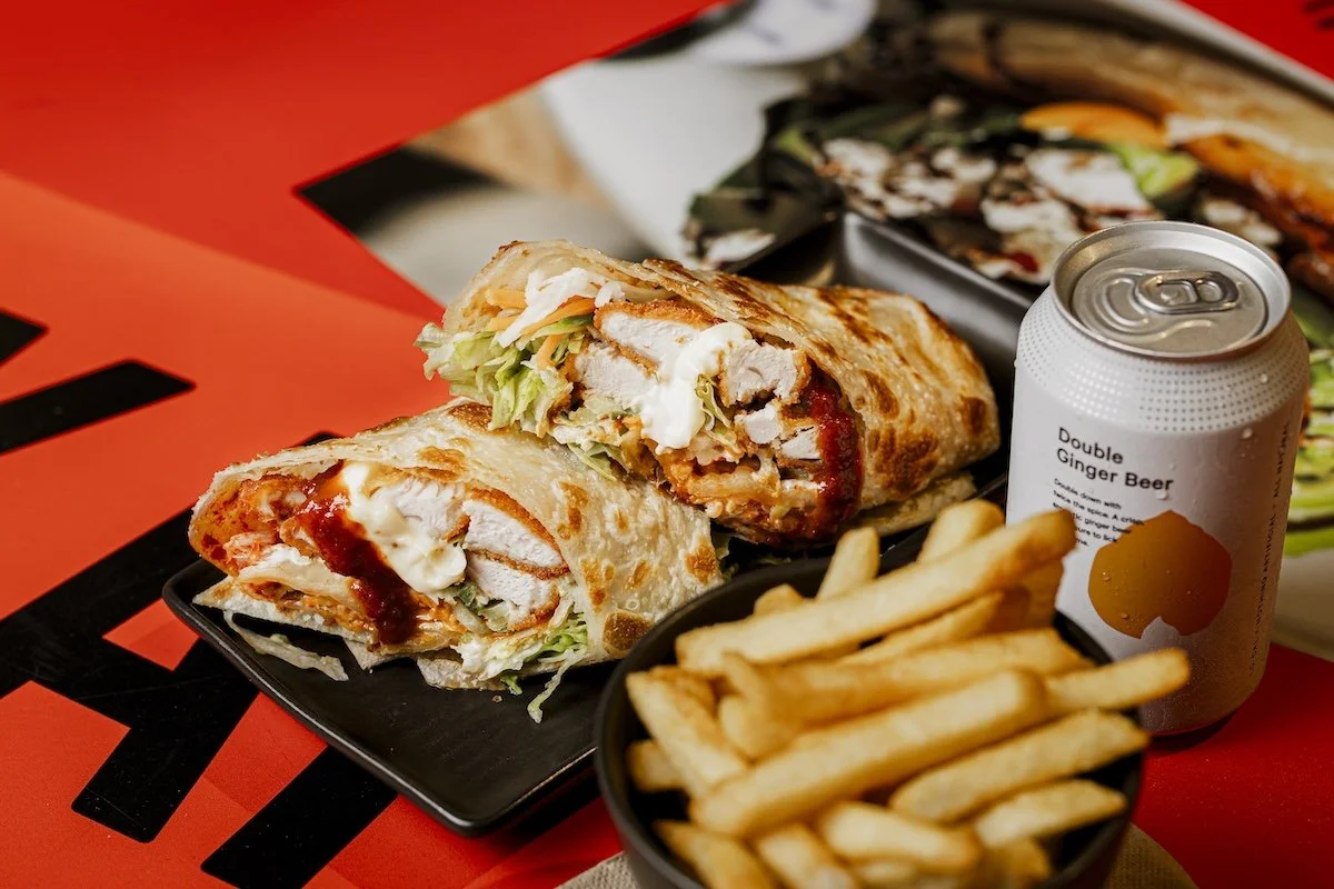 Korean fried chicken roti wrap with kimchi, chips and a StrangeLove Double Ginger Beer, at Kafe Kooks, Ultimo