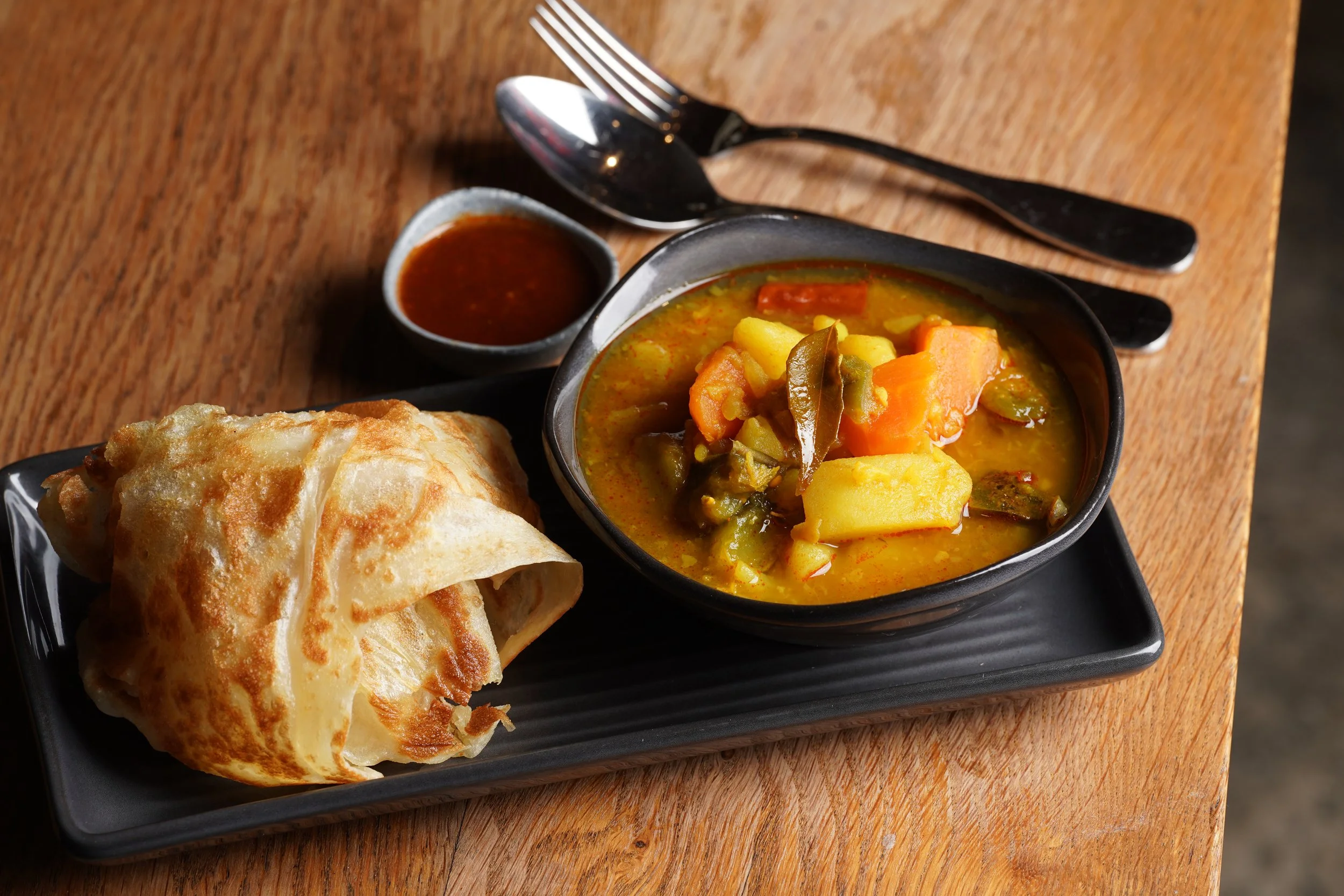 Vegetable dhal curry with roti paratha and a side of house-made sambal, at Kafe Kooks, Ultimo