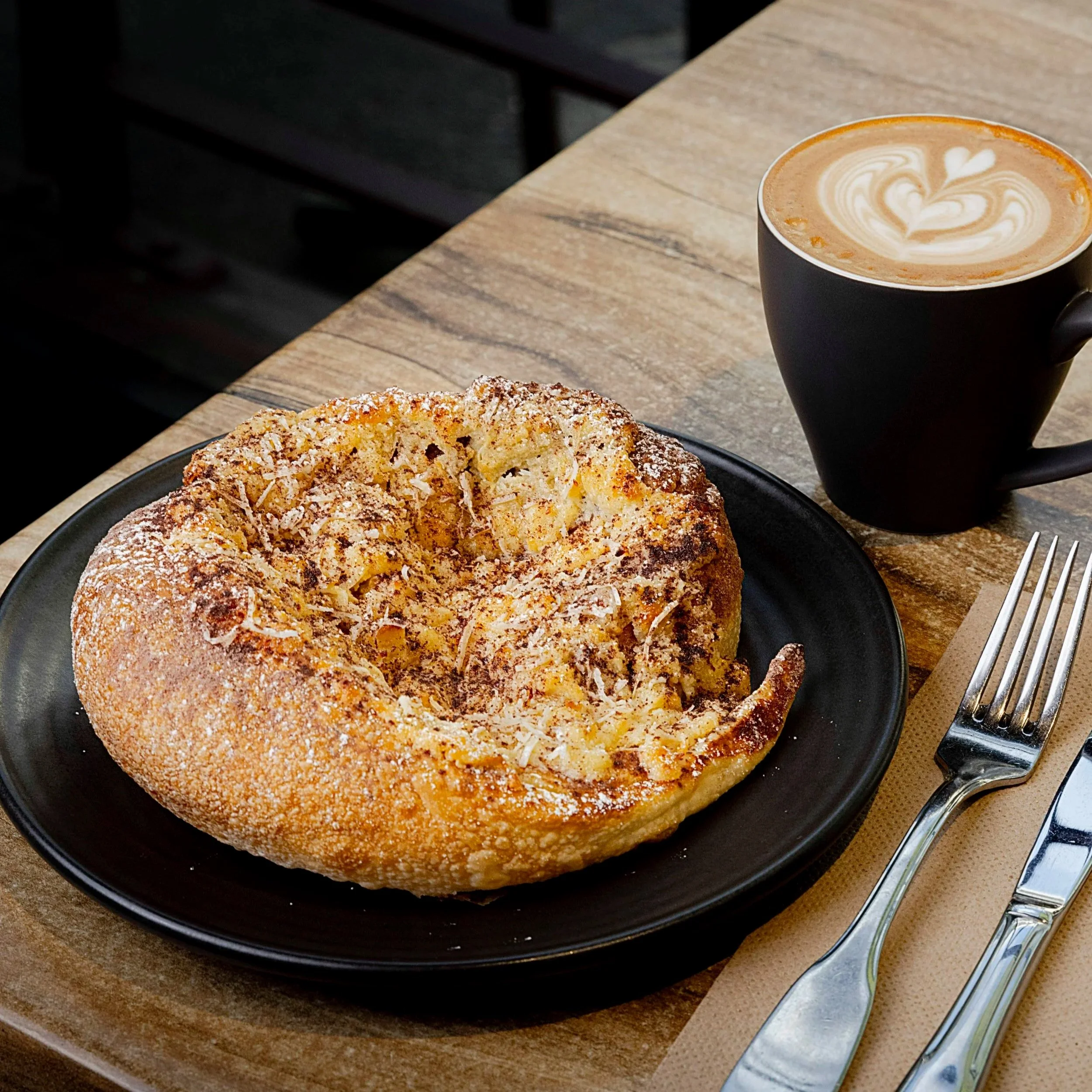 Lamington Helix roti croissant with raspberry jam, chocolate and coconut, and a flat white, at Kafe Kooks, Ultimo