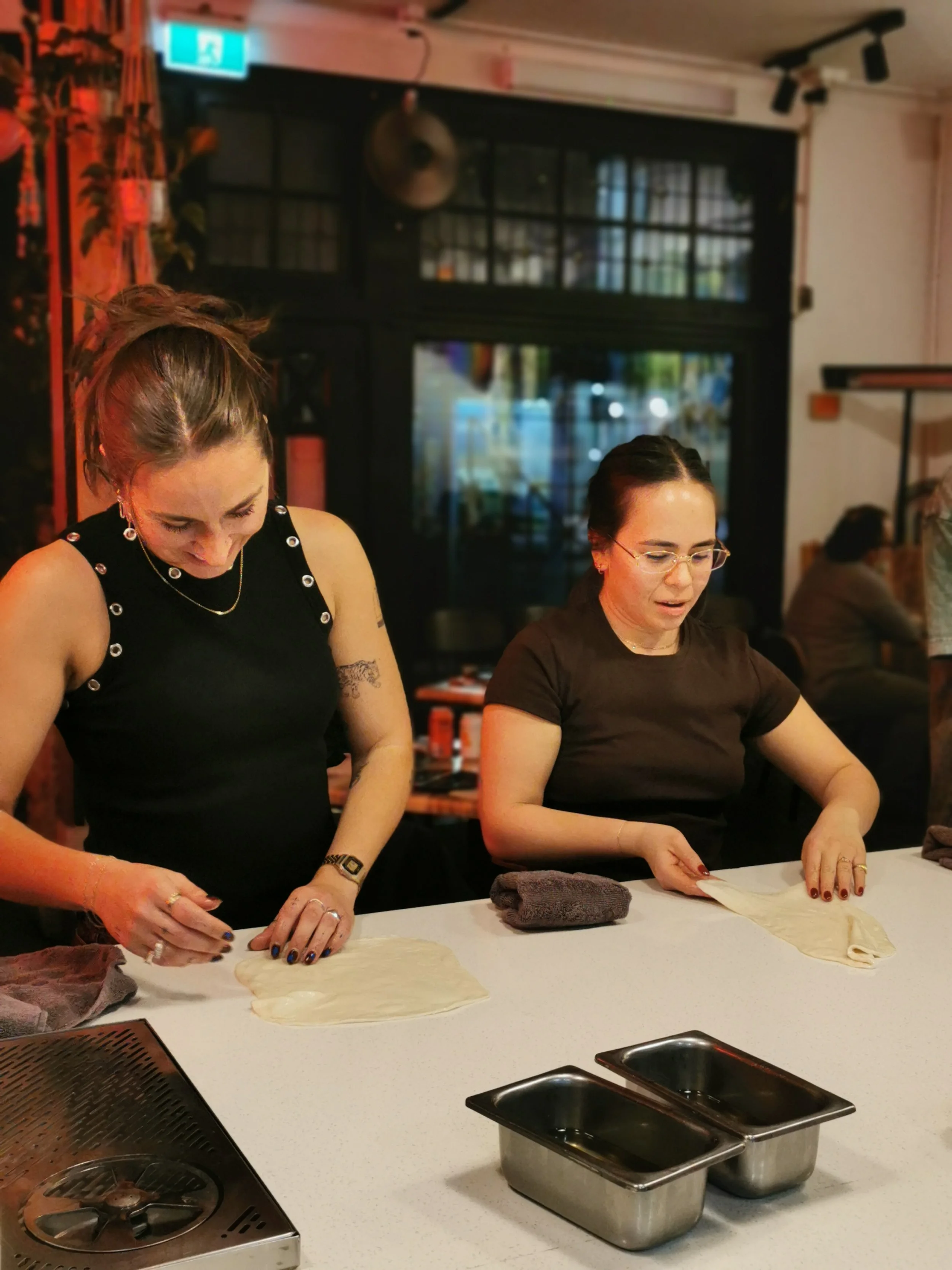 Learning the traditional roti stretch at Kafe Kooks Masterclass