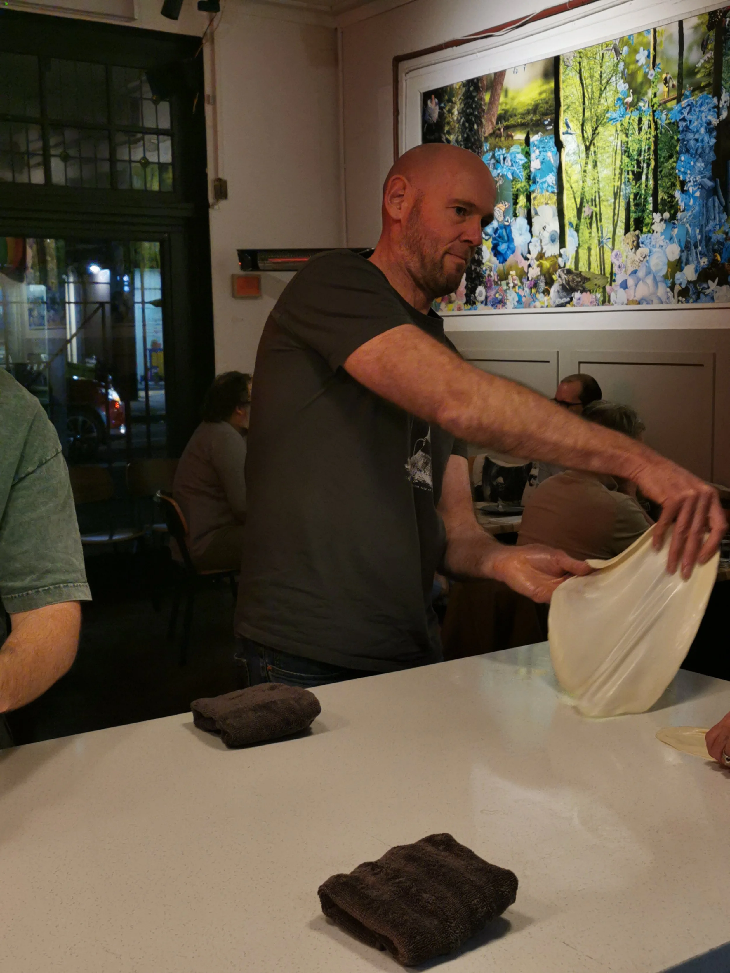 Guest attempting the roti flip at Kafe Kooks, Ultimo Sydney