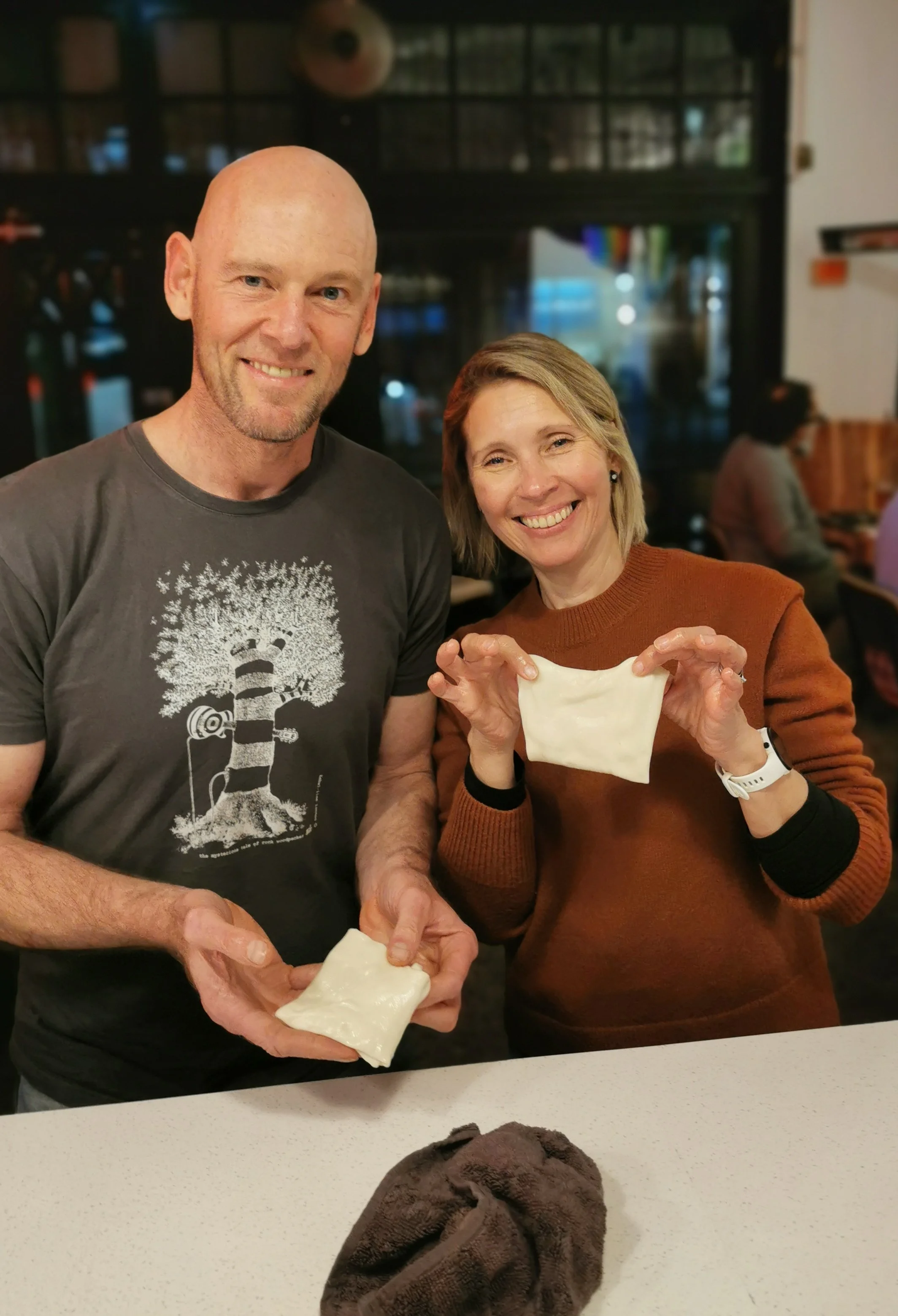 Guest smiling with their roti creation at Kafe Kooks Masterclass