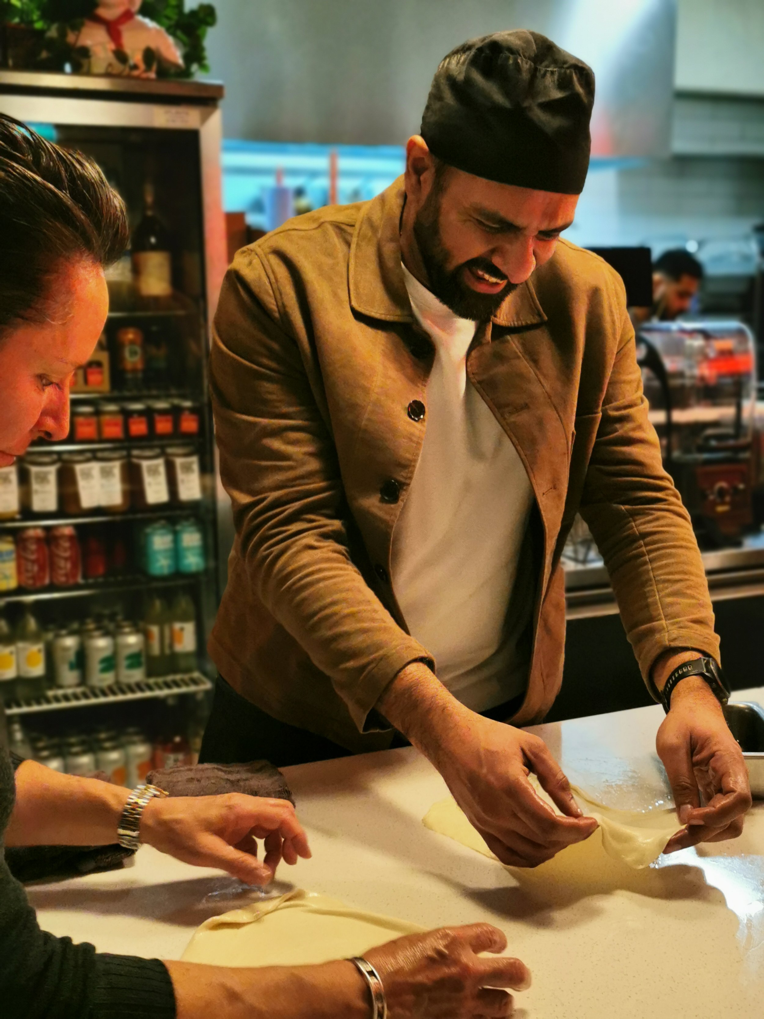 Guest concentrating while stretching roti dough, Kafe Kooks Ultimo