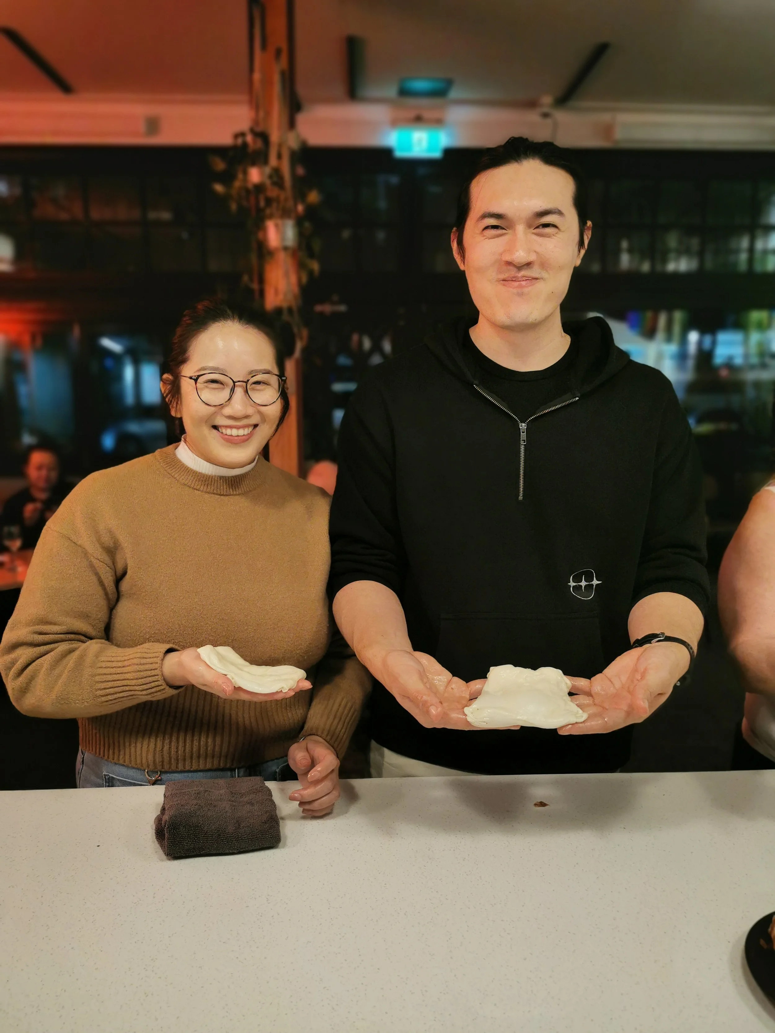Guest proudly holding their finished roti at Kafe Kooks Masterclass
