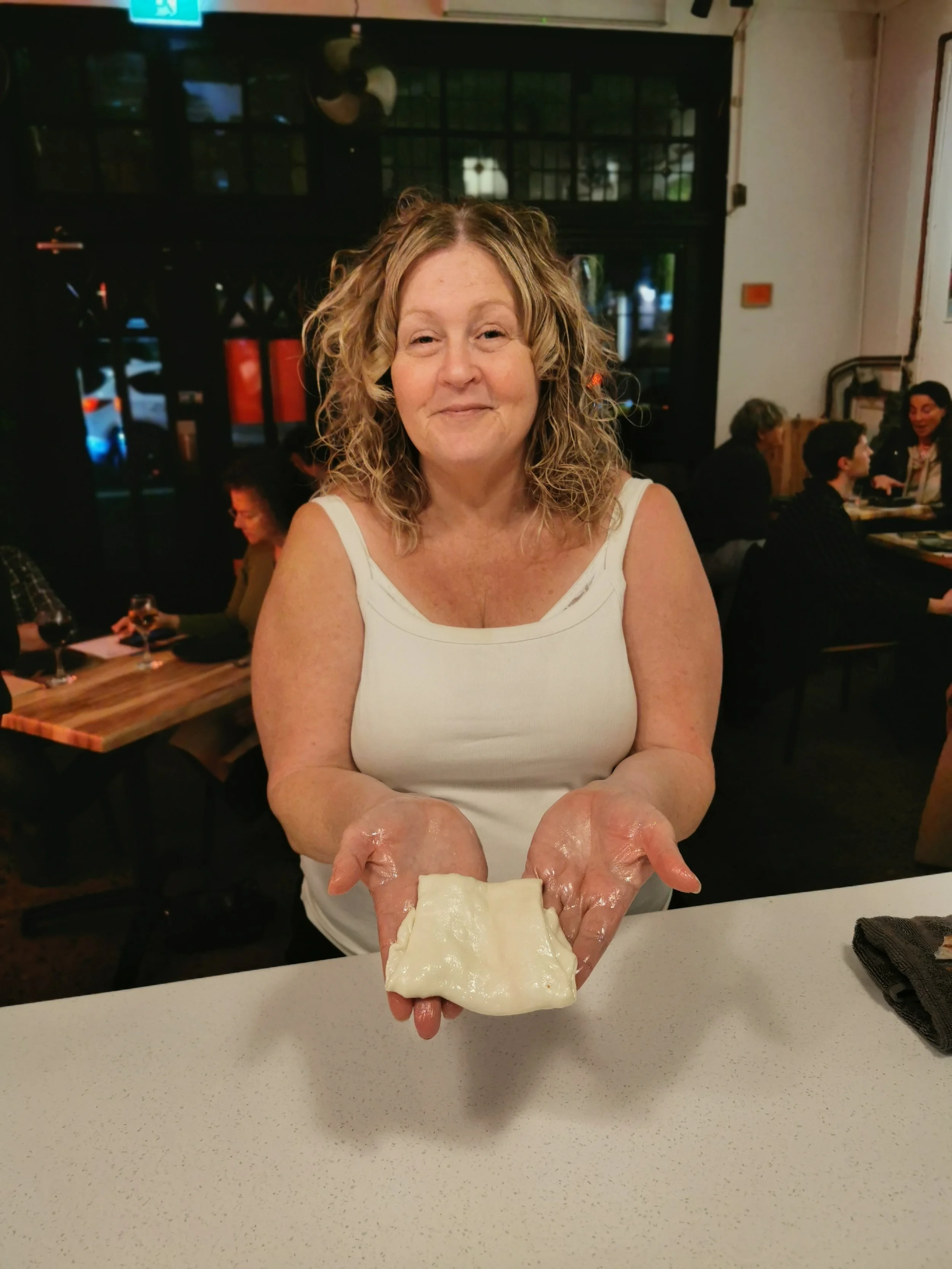 Guest posing with their homemade roti at Kafe Kooks, Ultimo