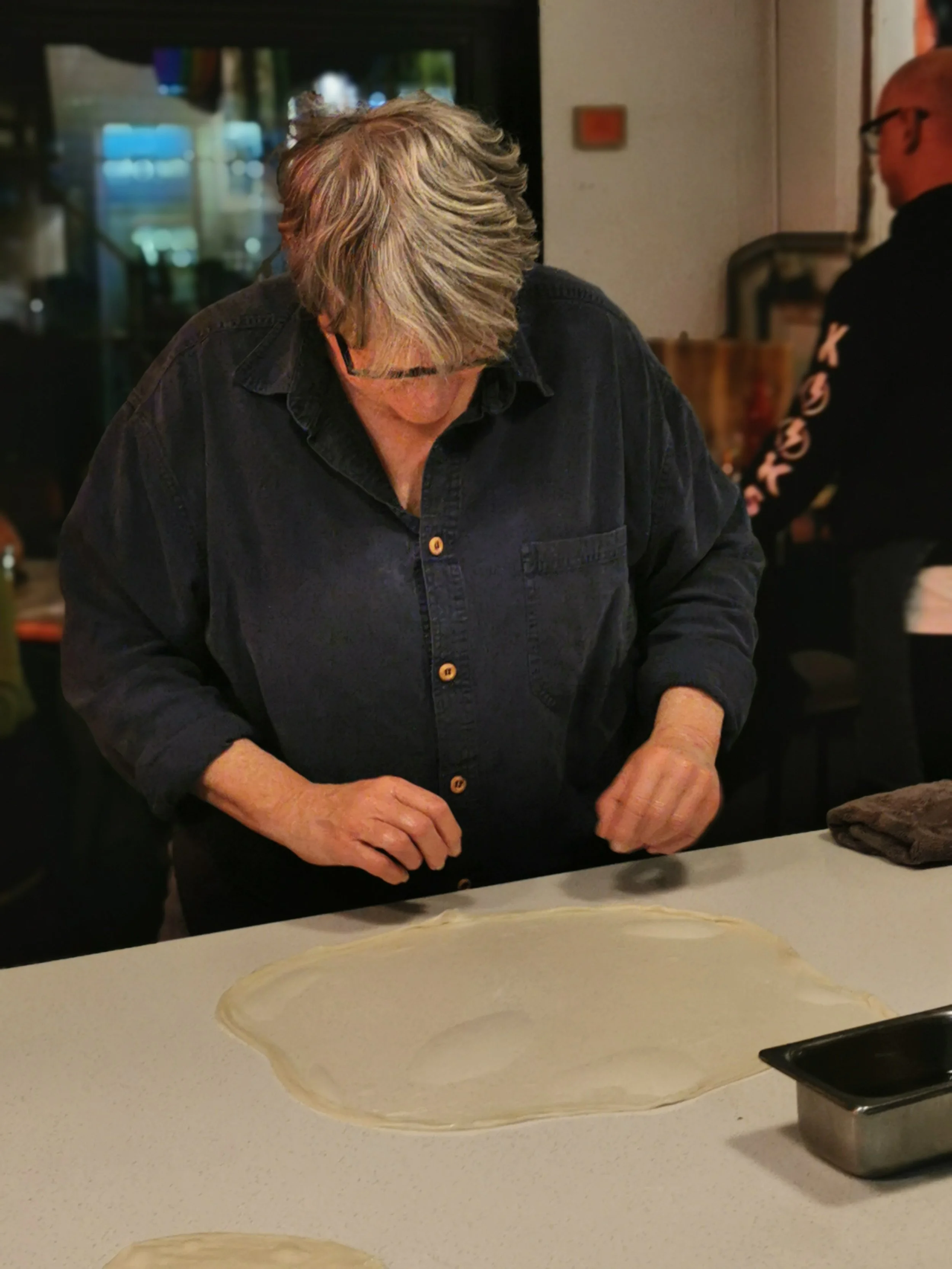 Learning the traditional roti stretch at Kafe Kooks Masterclass