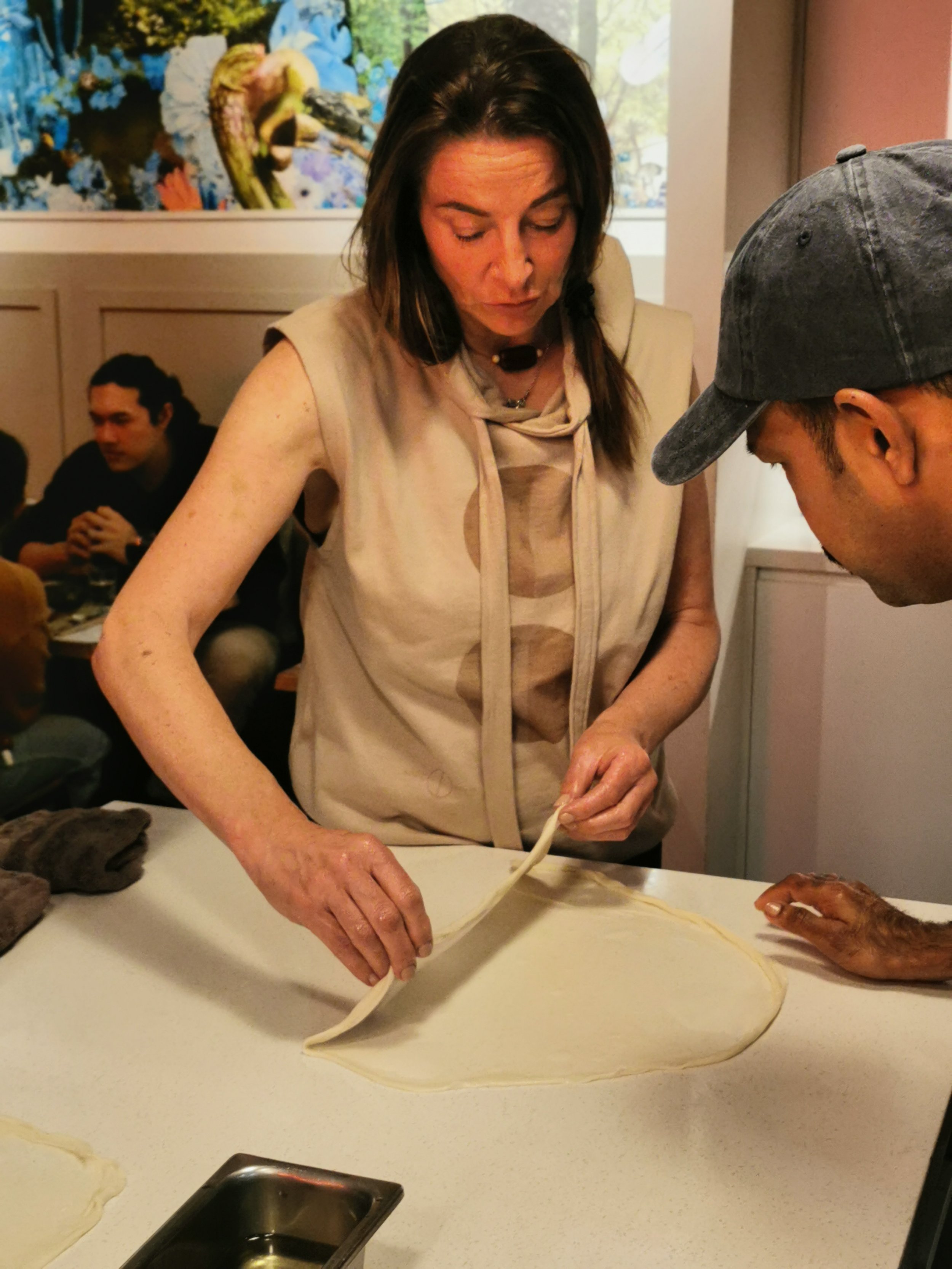 Guest stretching roti dough thin under Suresh's guidance, Ultimo Sydney