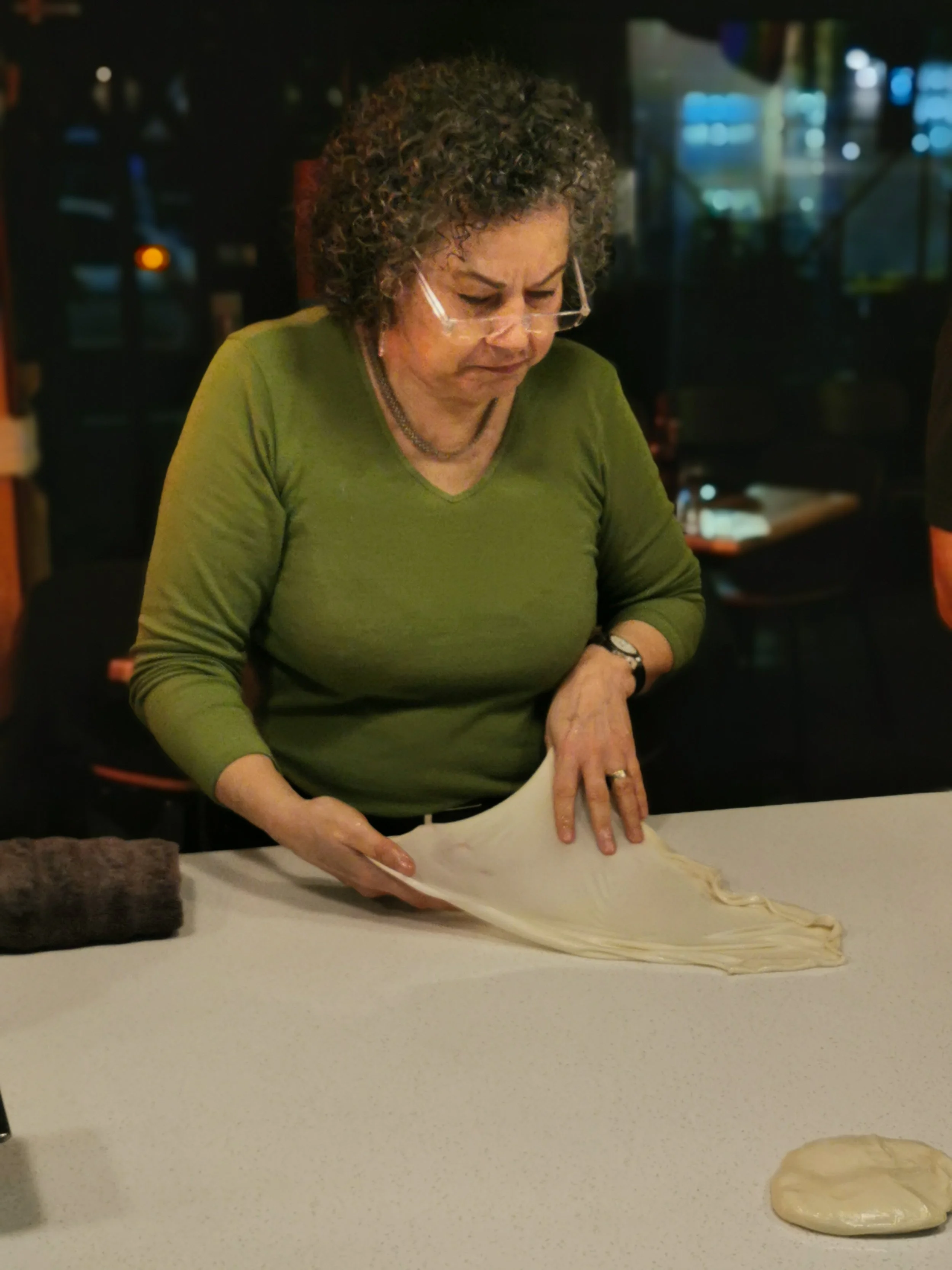 Guest learning the roti stretching the old fashion way at Kafe Kooks Thursday class