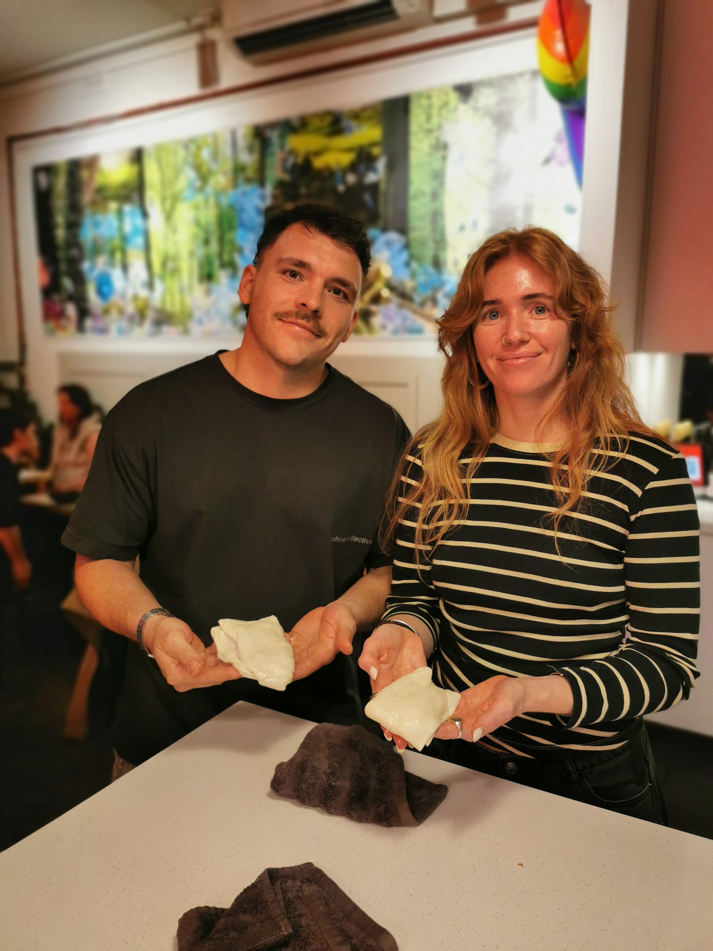 Guest holding up their completed roti at Kafe Kooks, Ultimo