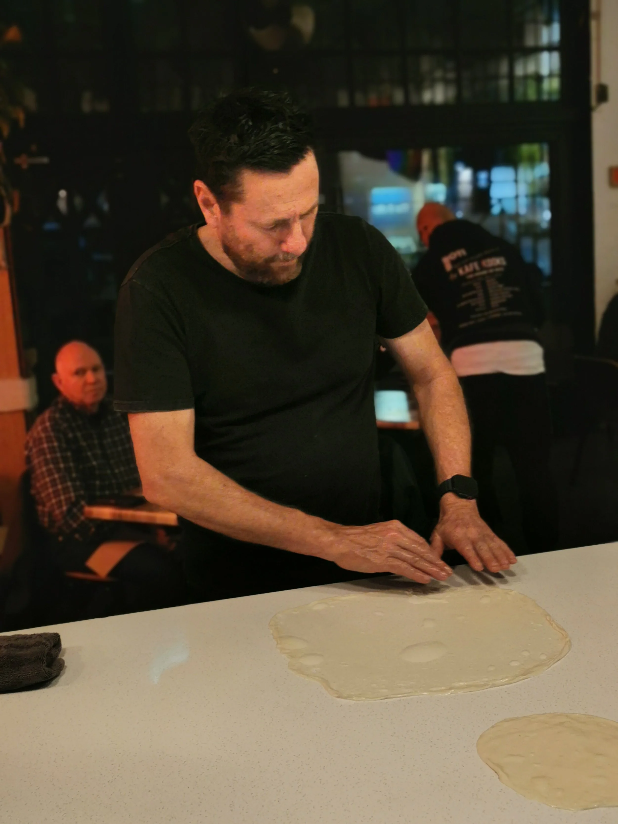 Guest concentrating while stretching roti dough, Kafe Kooks Ultimo