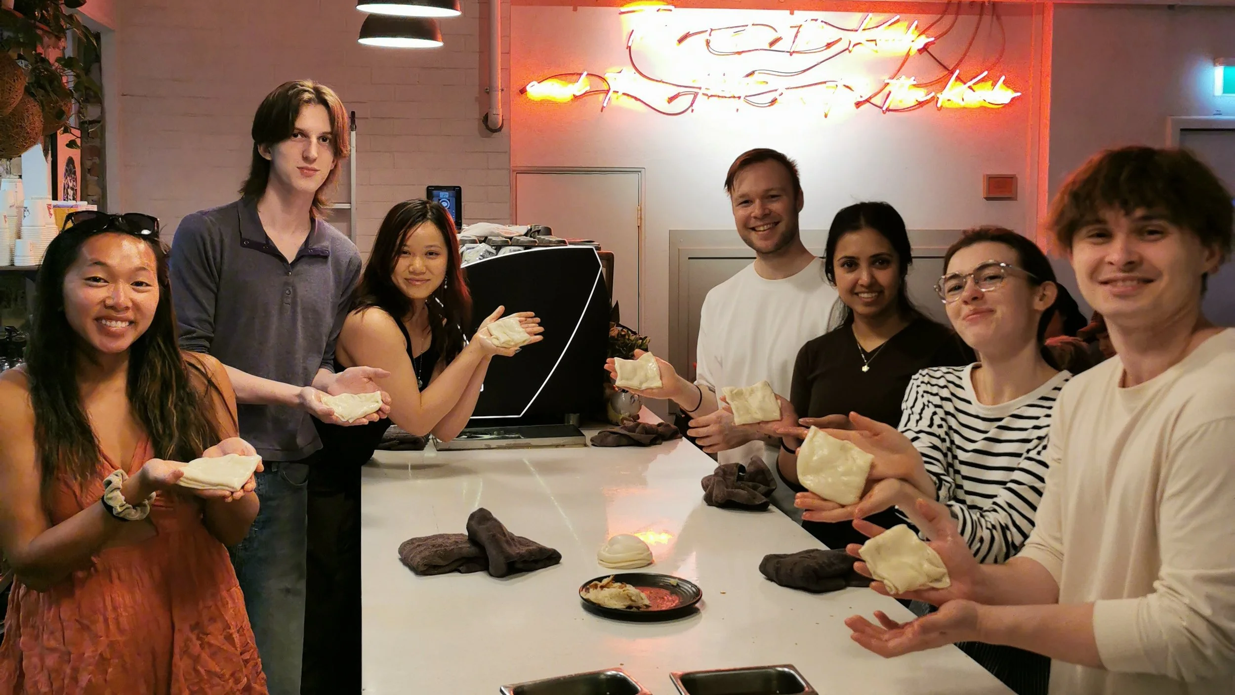 Guests posing with their handmade roti at Kafe Kooks, Ultimo