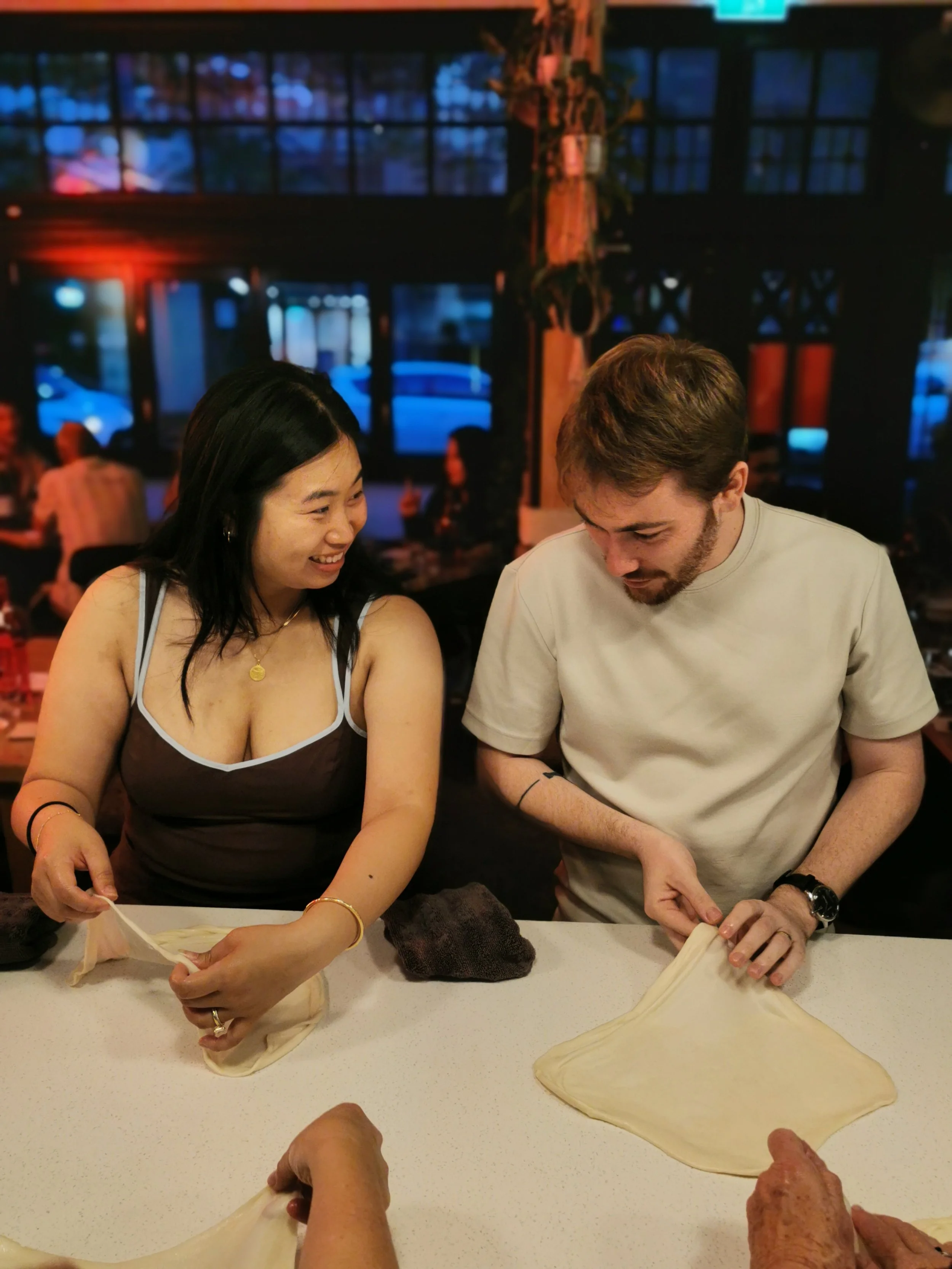 Guest learning the roti stretching the old fashion way at Kafe Kooks Thursday class