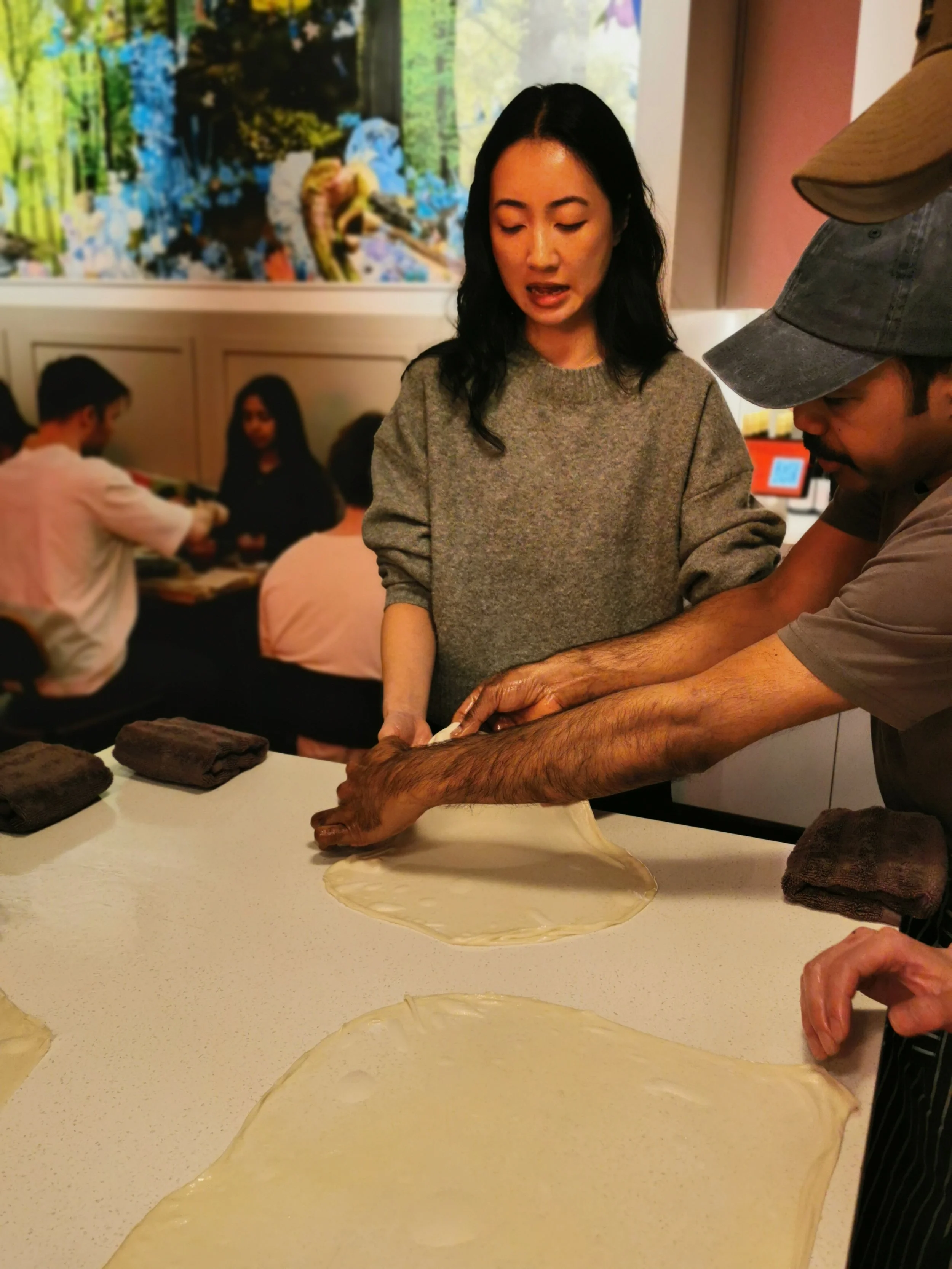 Guest stretching roti dough thin under Suresh's guidance, Ultimo Sydney