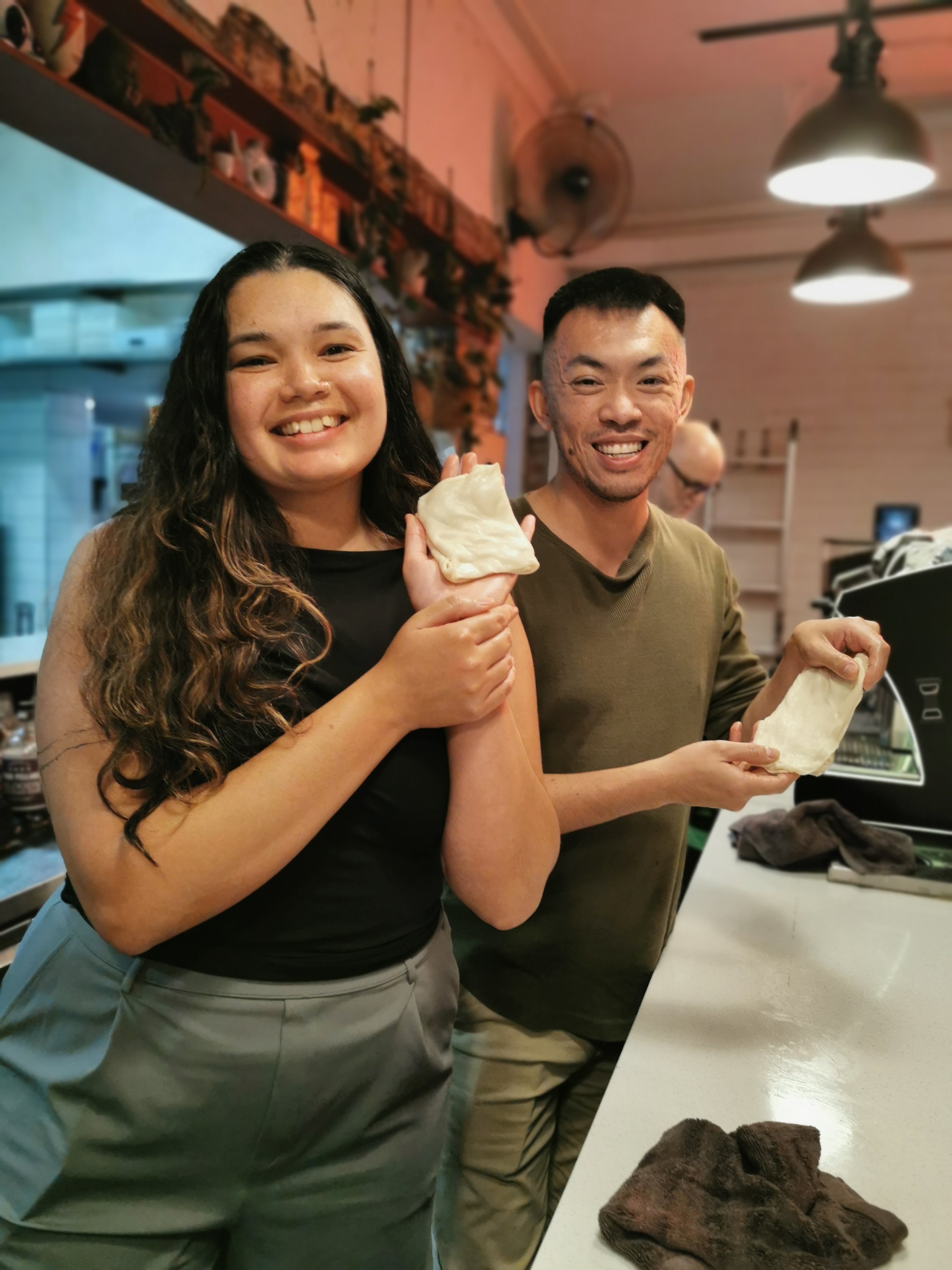 Proud guest with their first handmade roti at Kafe Kooks