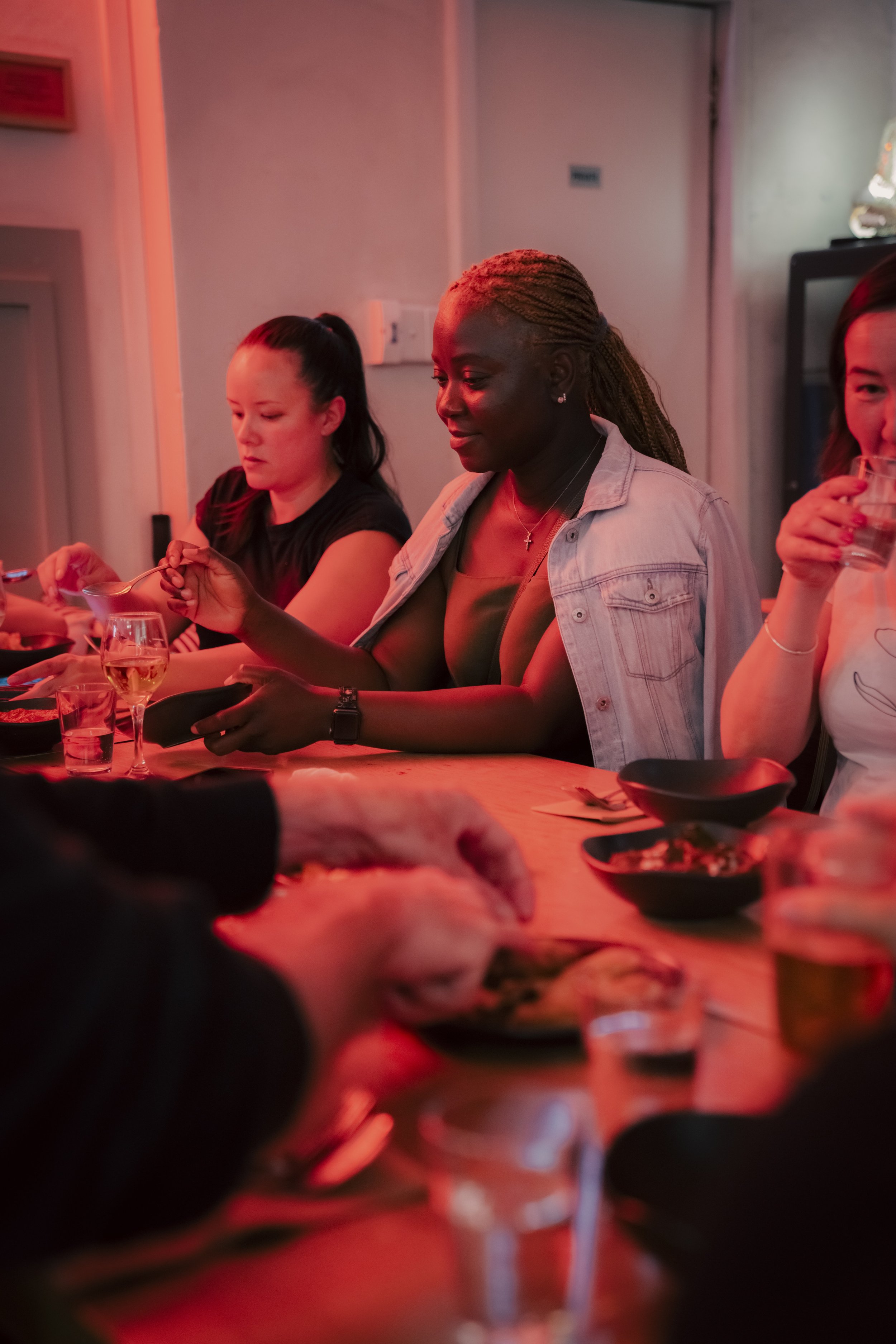 Guests enjoying a group dinner while others take part in the Kafe Kooks Roti Masterclass, a hands-on Christmas party and corporate team event in Sydney