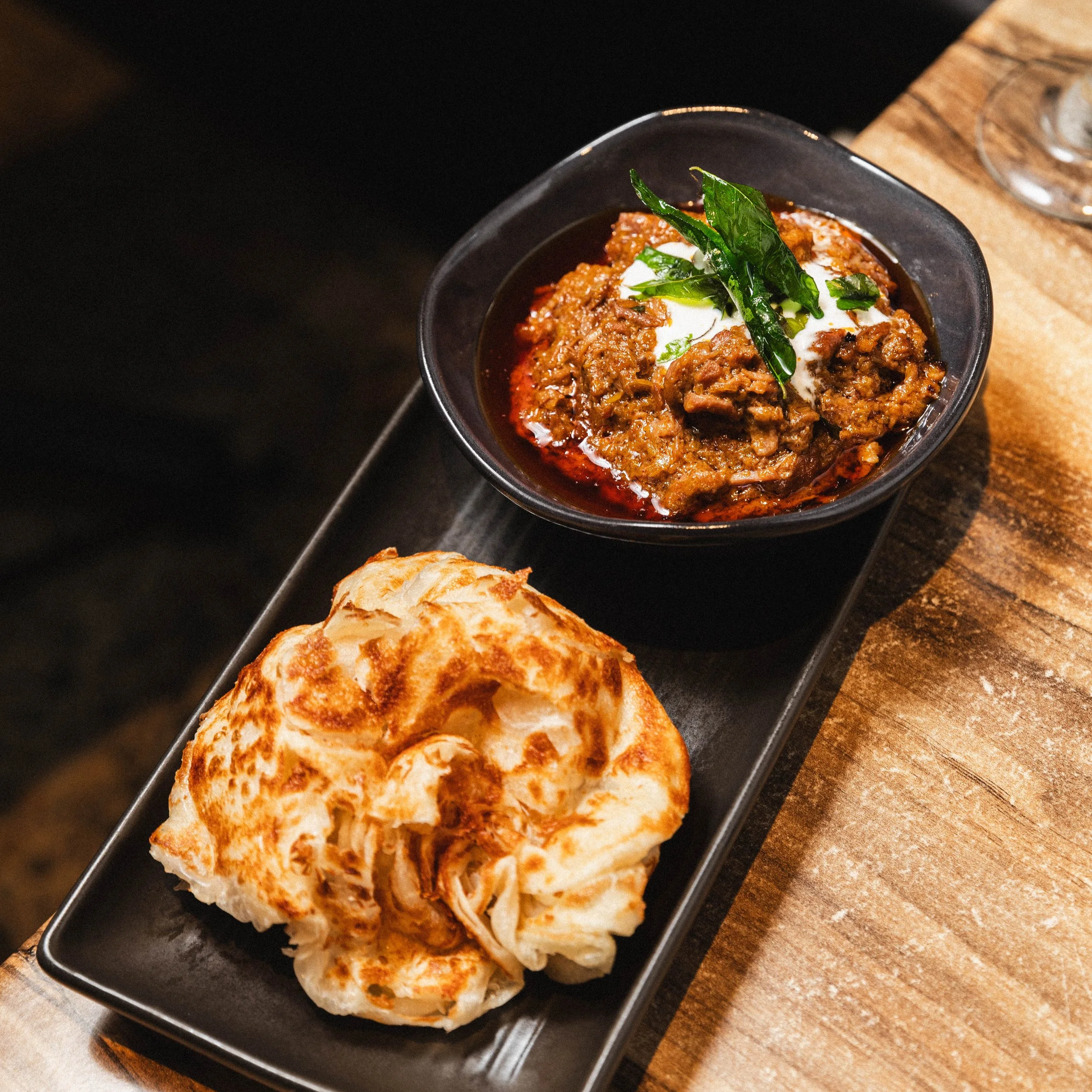 Beef rendang, dry-style coconut beef curry served with roti paratha, at Kafe Kooks, Ultimo