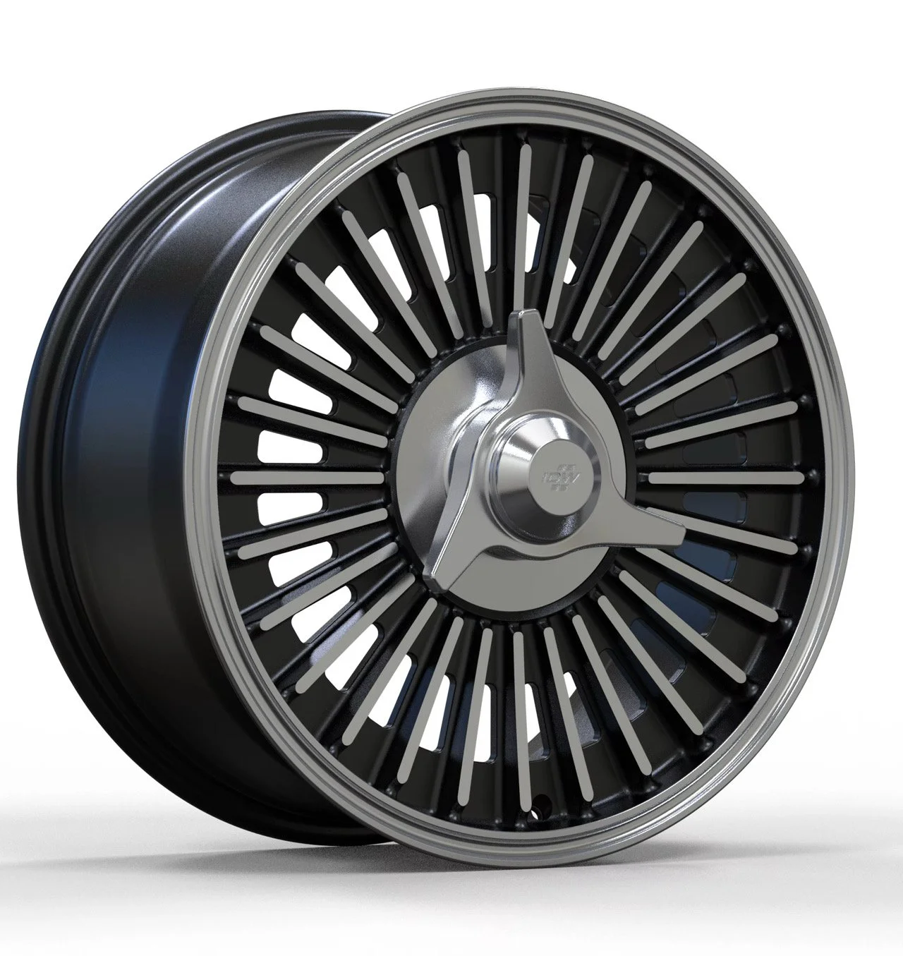 A car wheel with a black and silver rim and a three-spoke metallic hubcap centered on the rim.