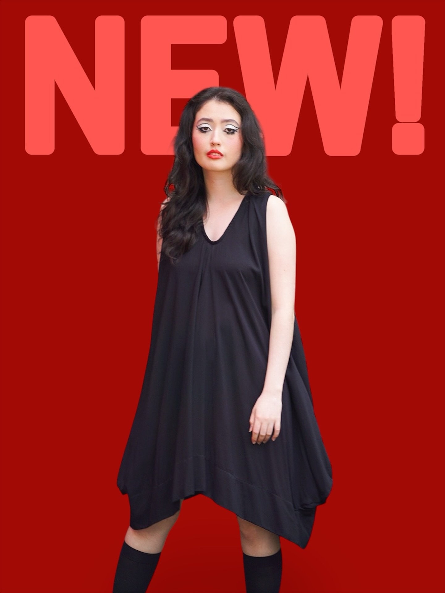 This striking black dress is crafted from lightweight cotton, perfect for effortless layering and movement. It features a deep V neckline and a unique draped hem with subtle strapping details that create a sculptural silhouette. Flowing and comfortab