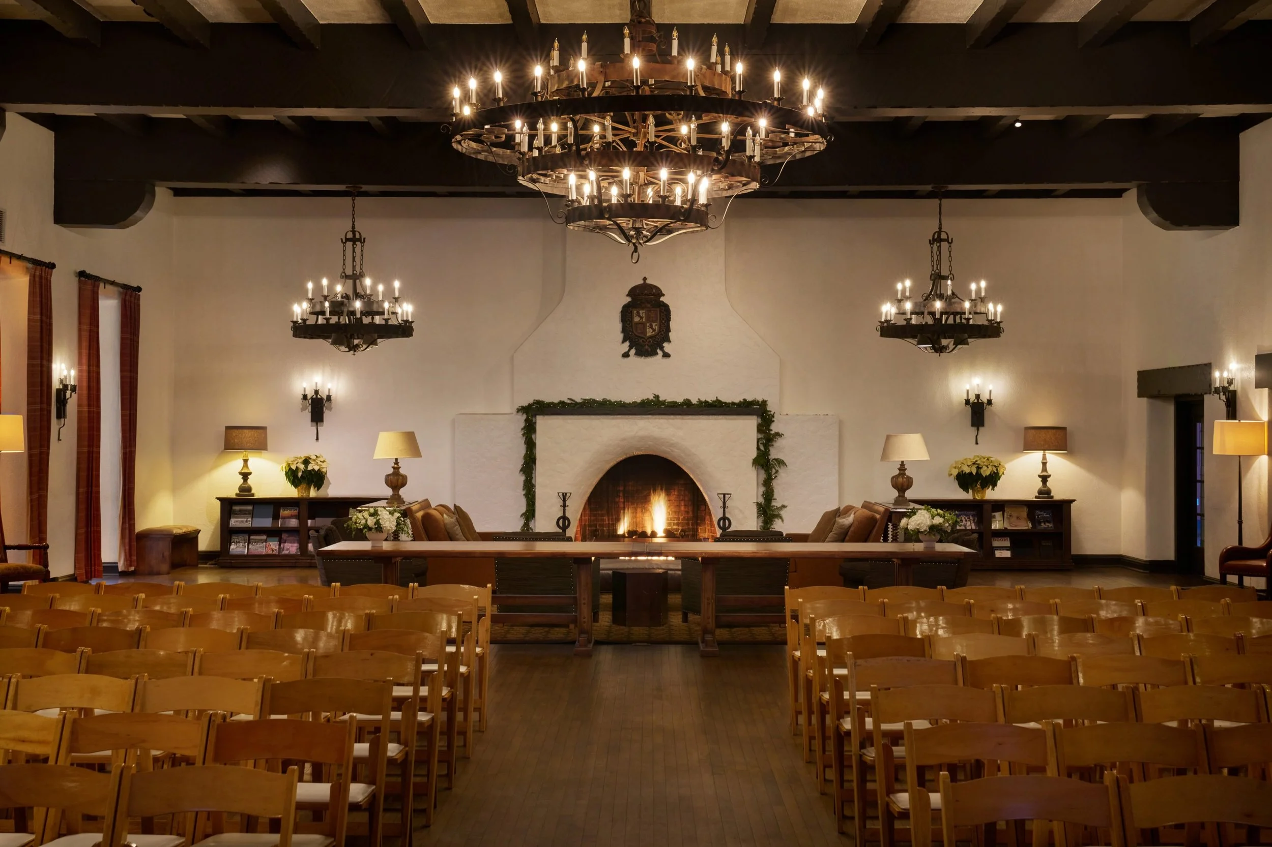 Moraga Hall at Presidio Officers’ Club in San Francisco, with chandeliers, wooden beams and a fireplace