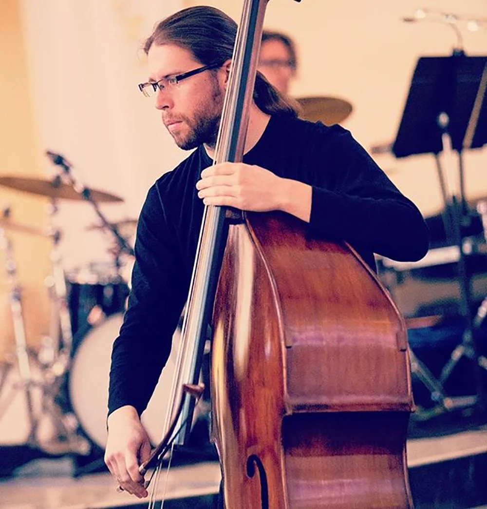 Pink Mozart double bassist performing on stage