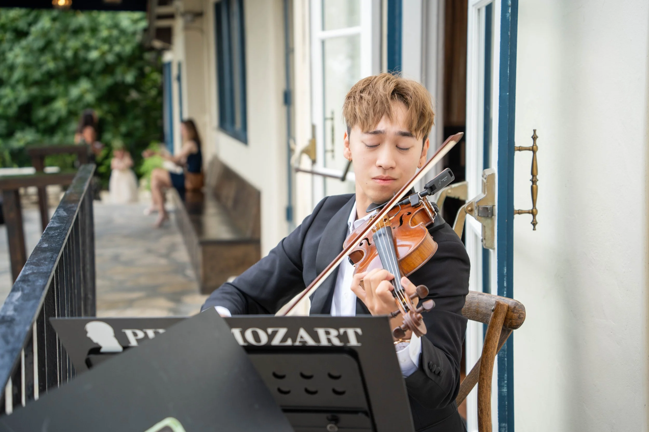 Pink Mozart violinist playing at an outdoor celebration