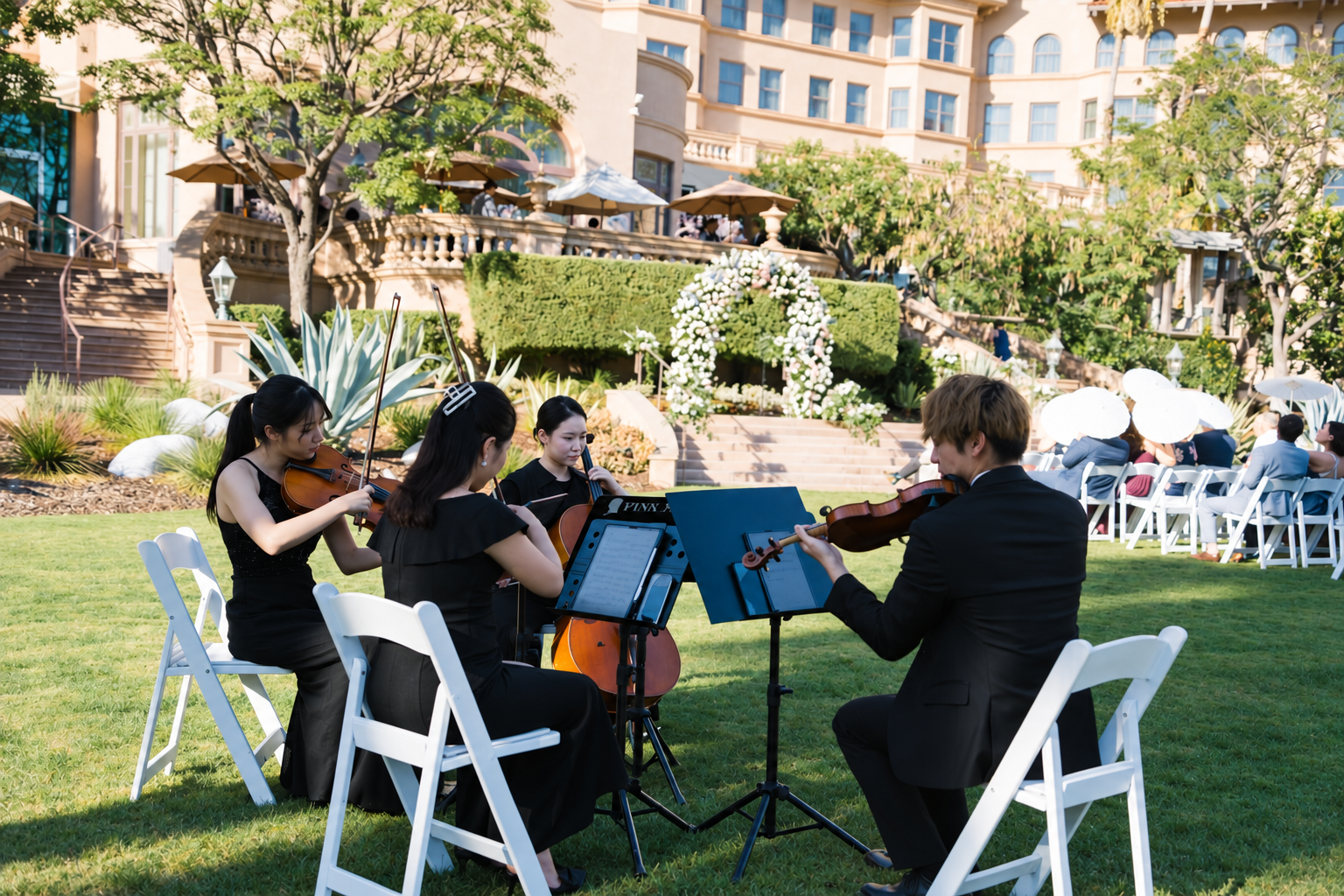Pink Mozart string quartet performing outdoors at The Langham Huntington, Pasadena, during a wedding