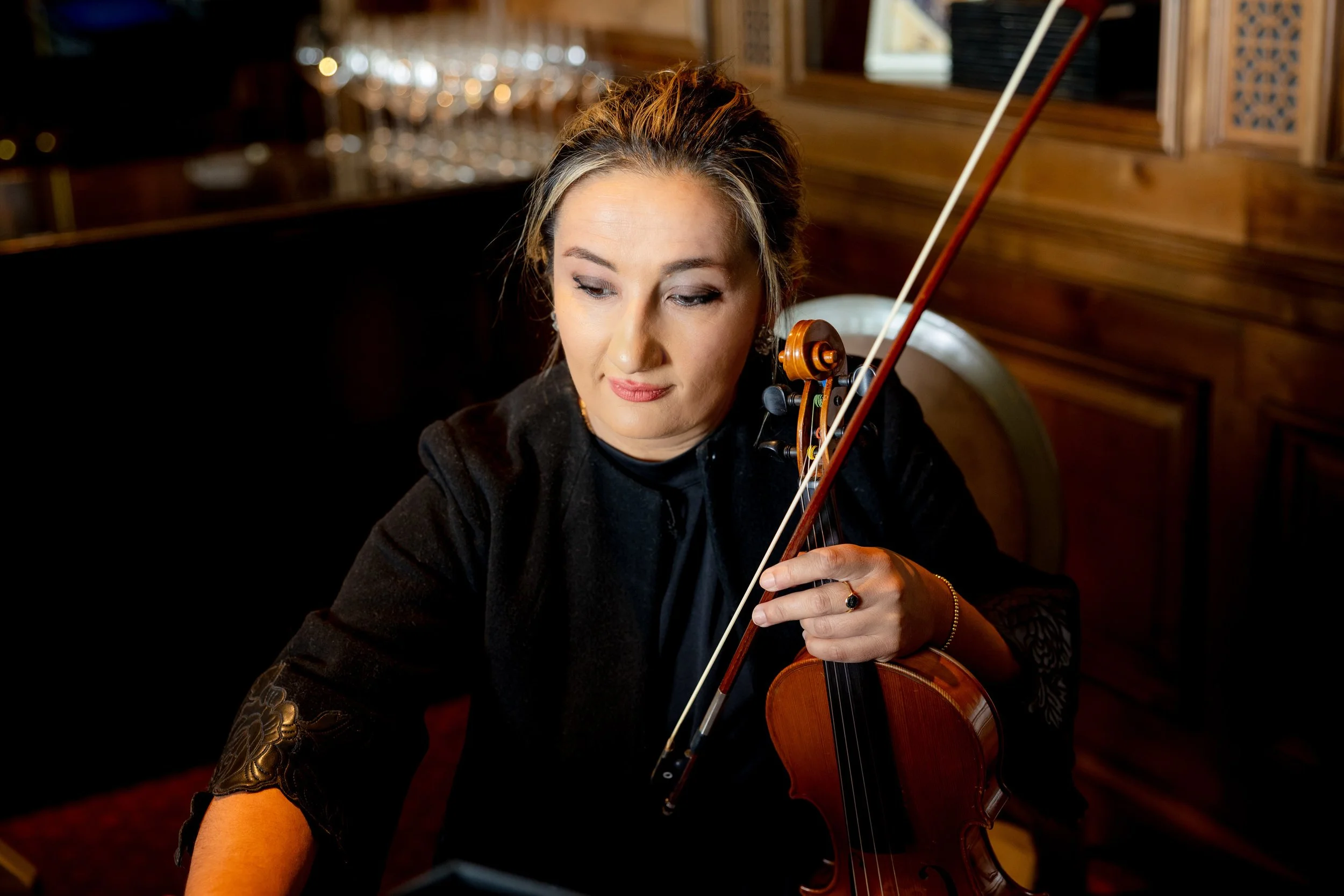 Pink Mozart violinist performing in a black concert dress