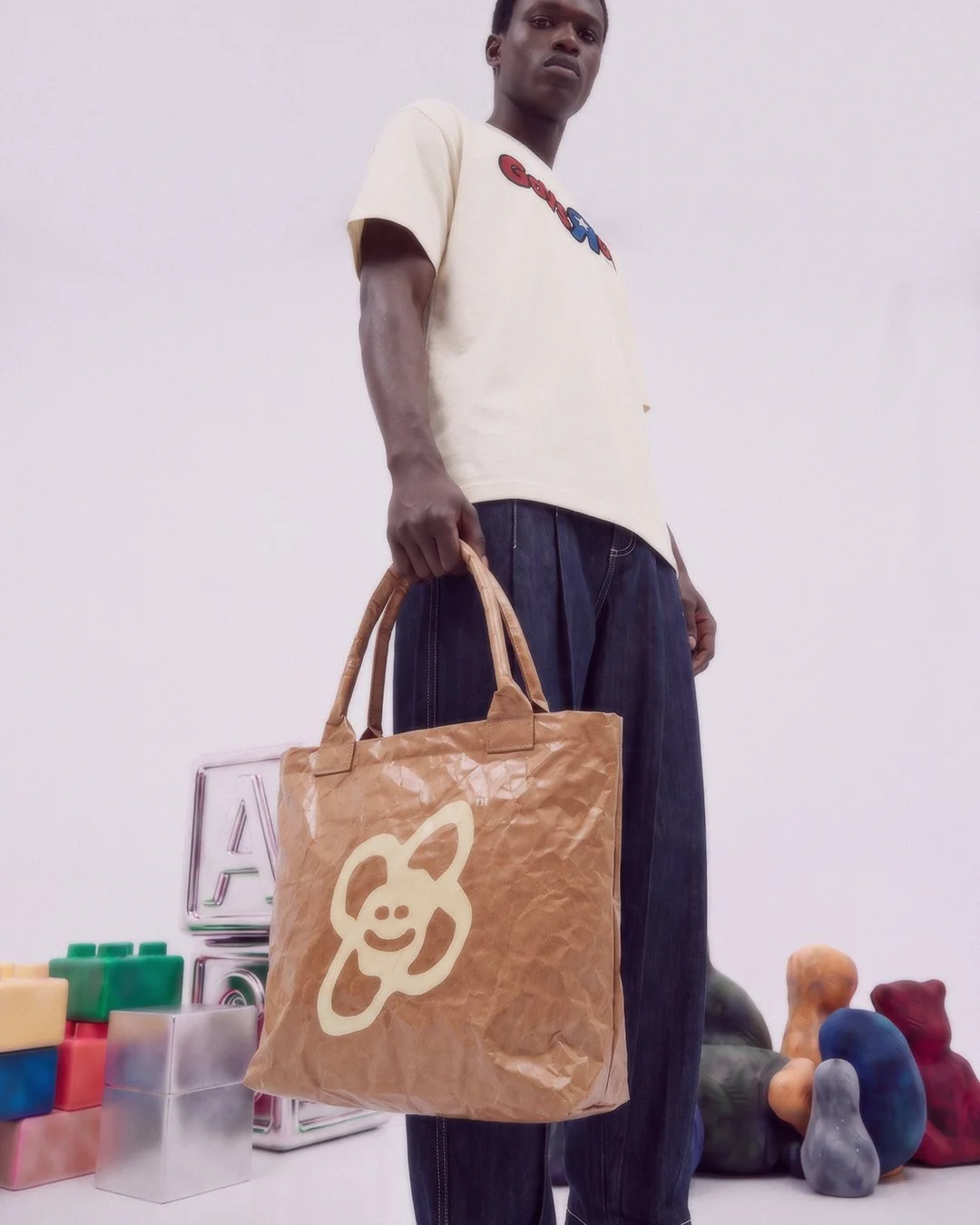 Male model carrying Brown Tote Bag by Artistrybeing