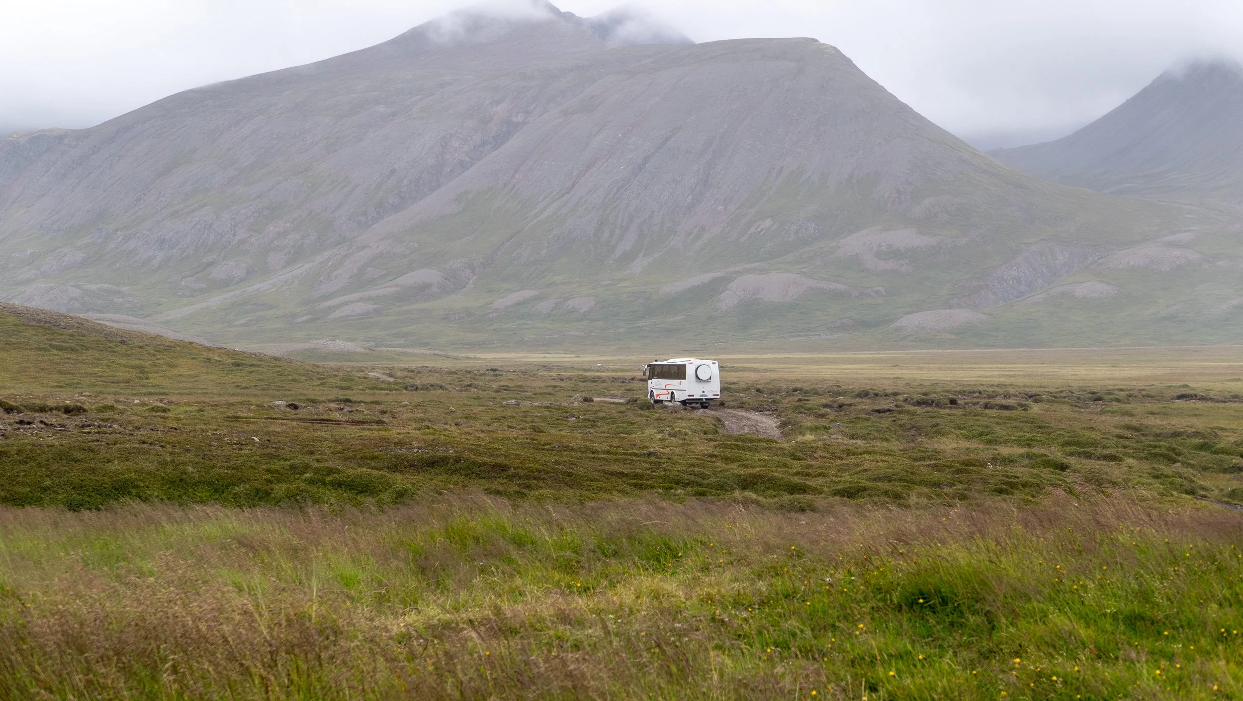 Tour bus leaving Flateyjardalur
