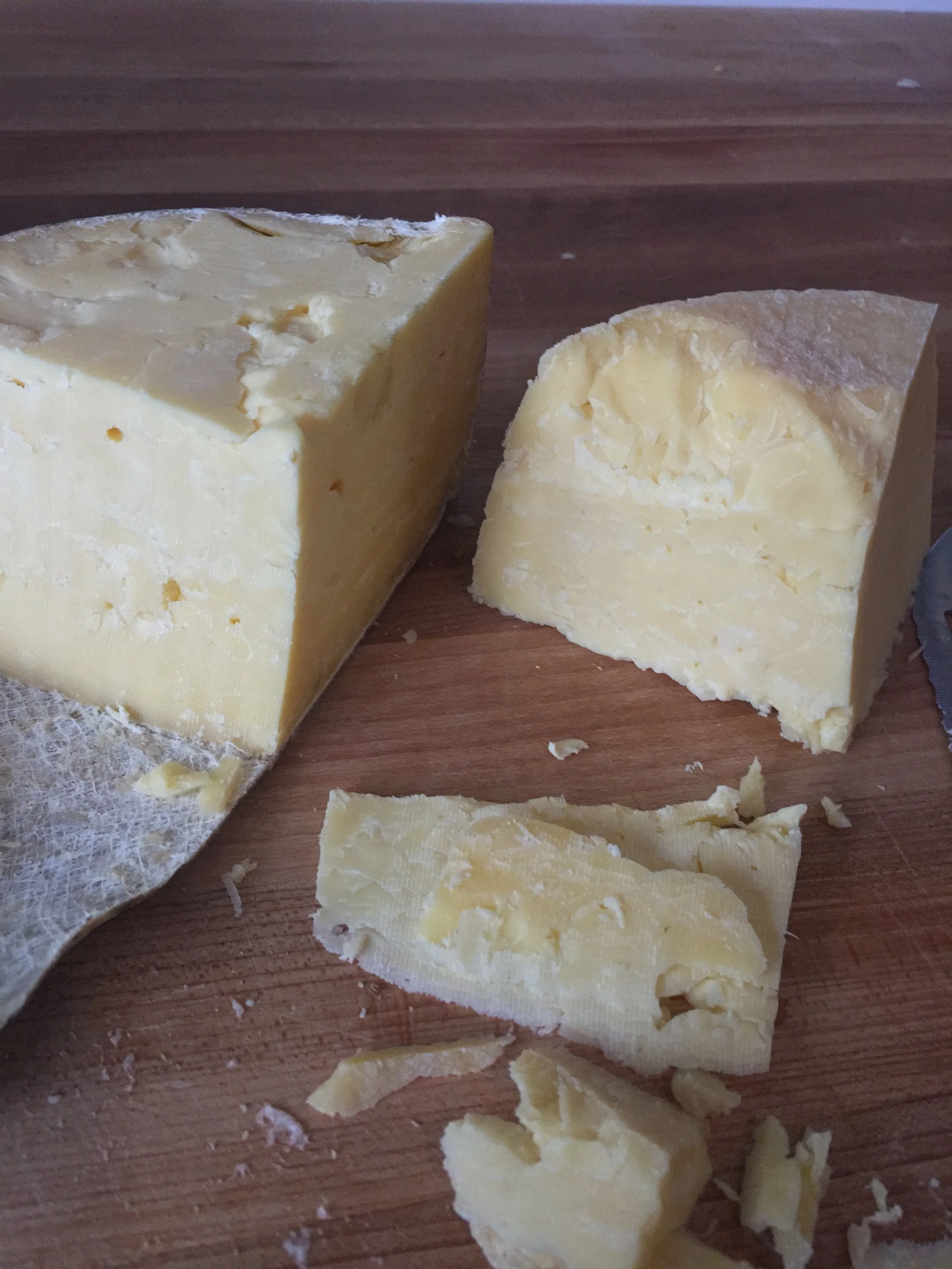 cut up natural cheese with cloth wrapping
