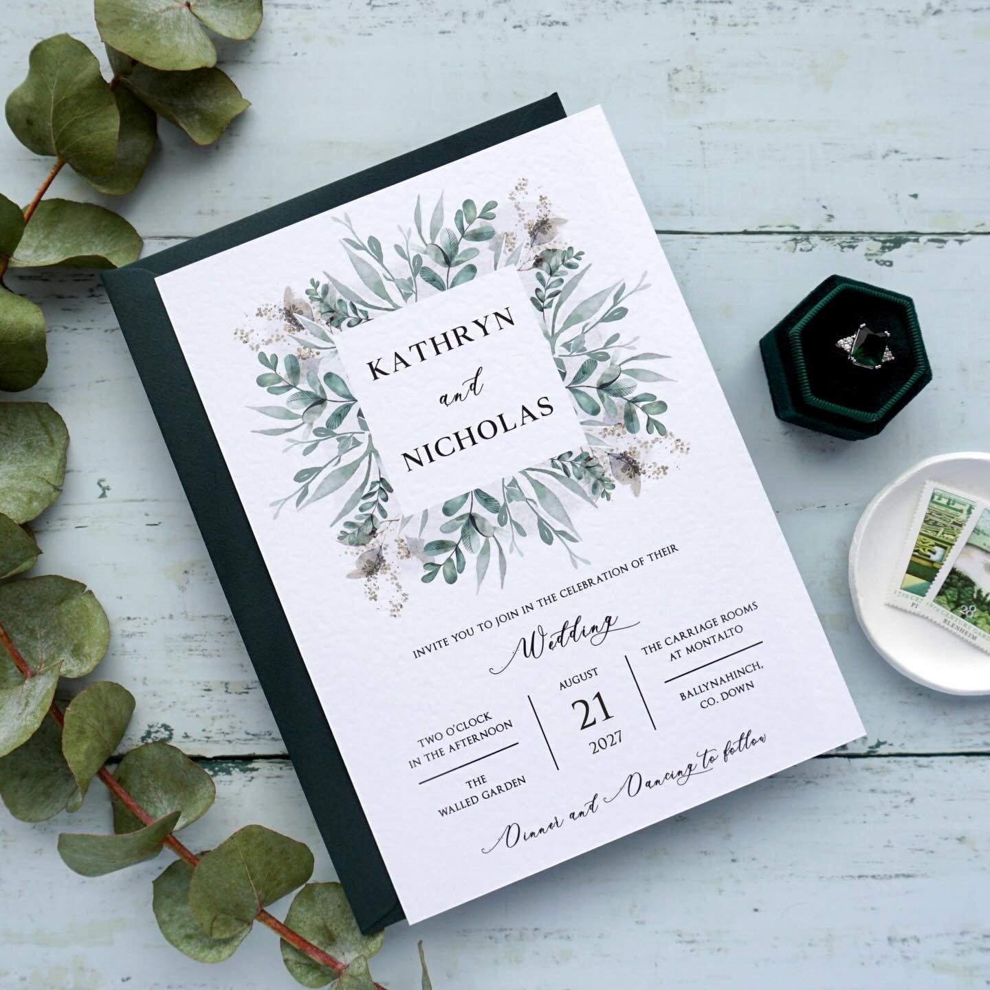 KATHRYN - This stylish suite offers beautiful eucalyptus detailing, printed on hammered cardstock and paired with a luxurious Hunter green envelope. Take these invites to the next level and upgrade to have the names stamped in hot foil... gold foil l