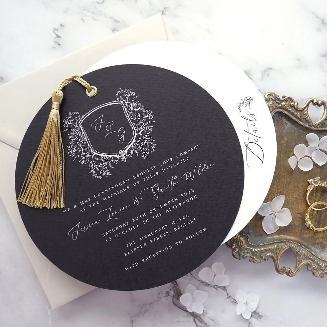 JESSICA - Featuring a circular cut invitation and details card, this design takes luxury to the next level. With a beautiful hand drawn crest, gold eyelet, matching tassel and paired with a premium almond envelope, the Jessica suite certainly makes a