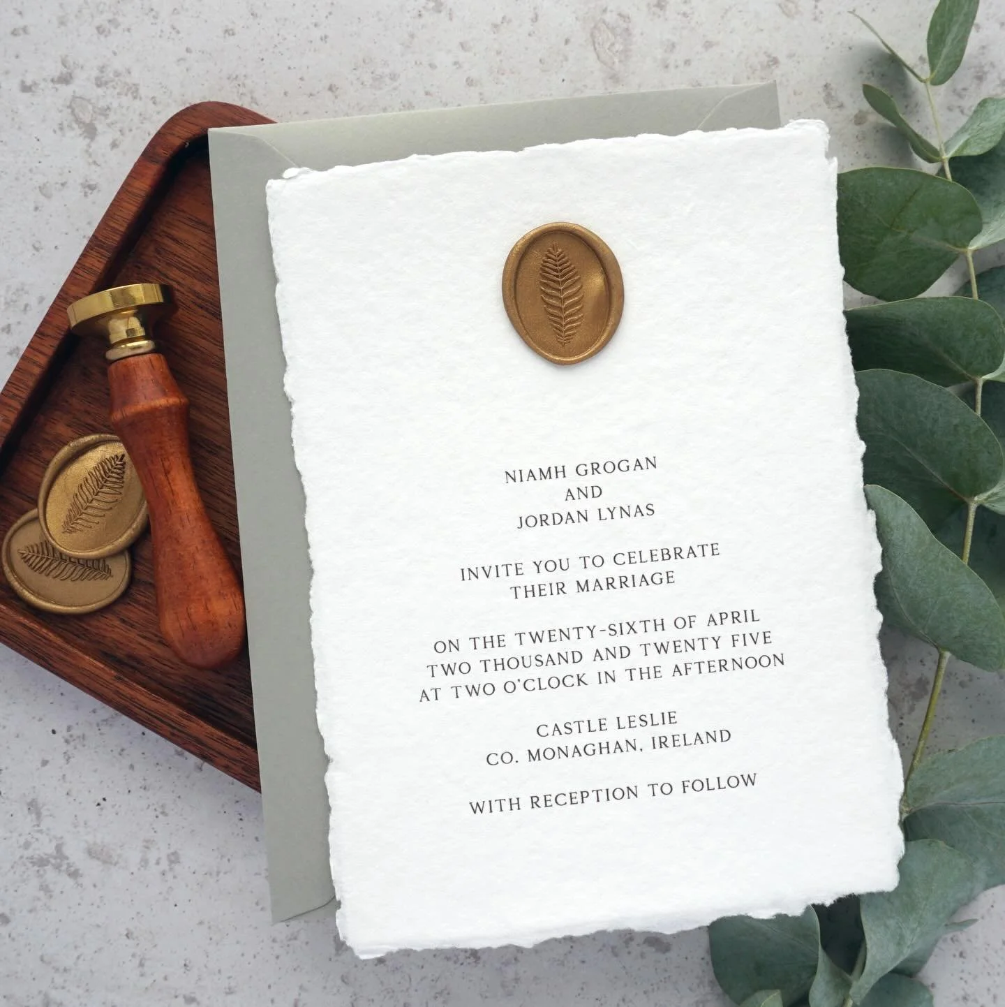 NIAMH - Printed on delicate handmade paper and finished with an oval wax seal, the Niamh suite screams sophistication. Seen here with a beautiful sage green envelope, but easily altered to match your colour scheme. Set the tone of your wedding with b