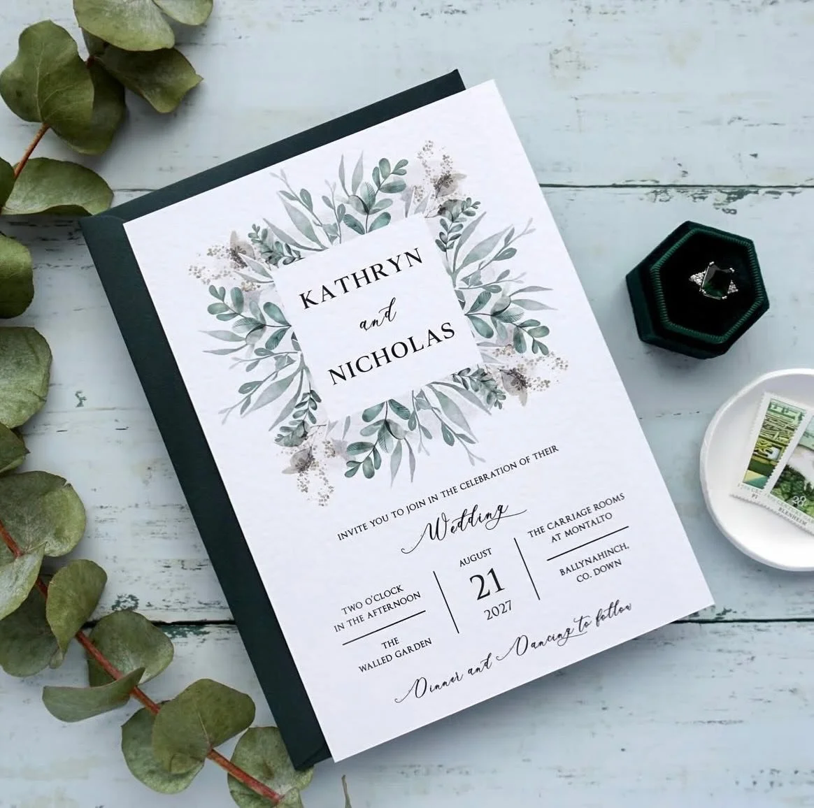 KATHRYN - This stylish suite offers beautiful eucalyptus detailing, printed on hammered cardstock and paired with a luxurious Hunter green envelope. Take these invites to the next level and upgrade to have the names stamped in hot foil... gold foil l